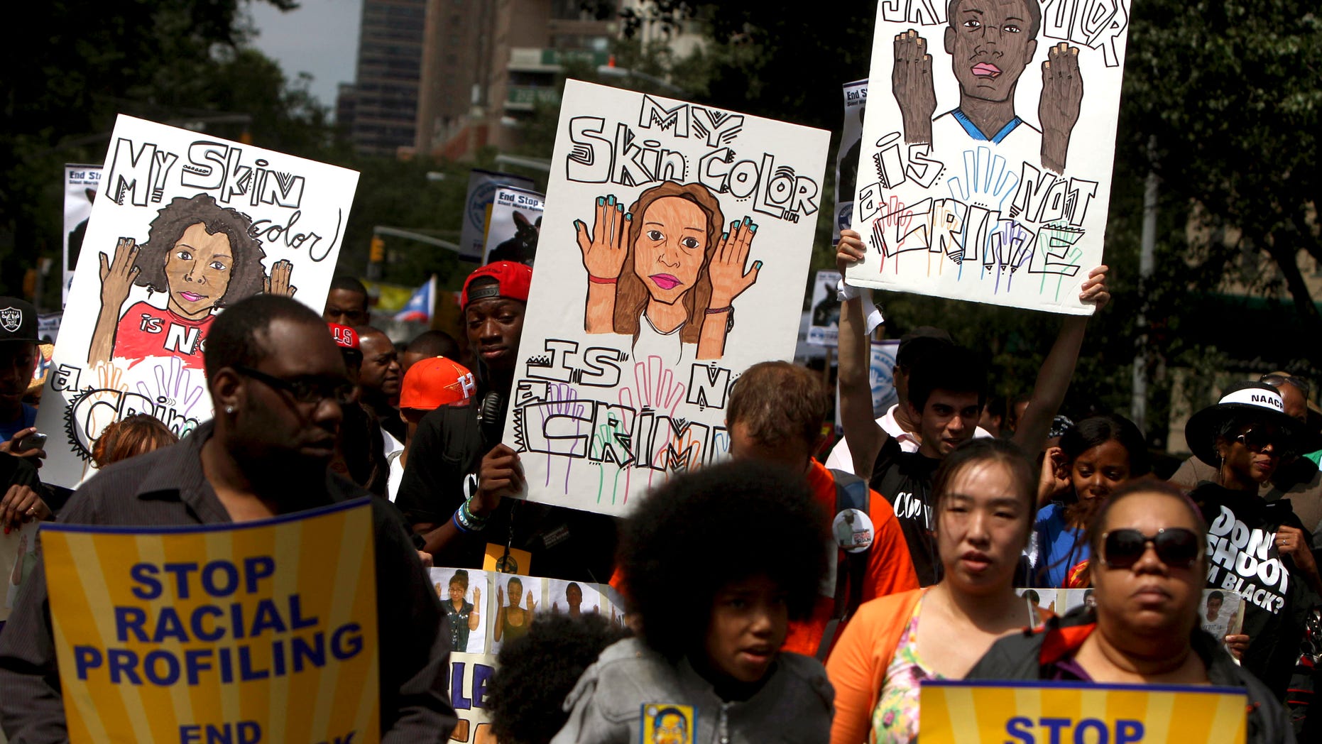 June 17, 2012: In this file photo, demonstrators hold signs during a silent march in New York to end the New York City Police Departments "stop-and-frisk" program.