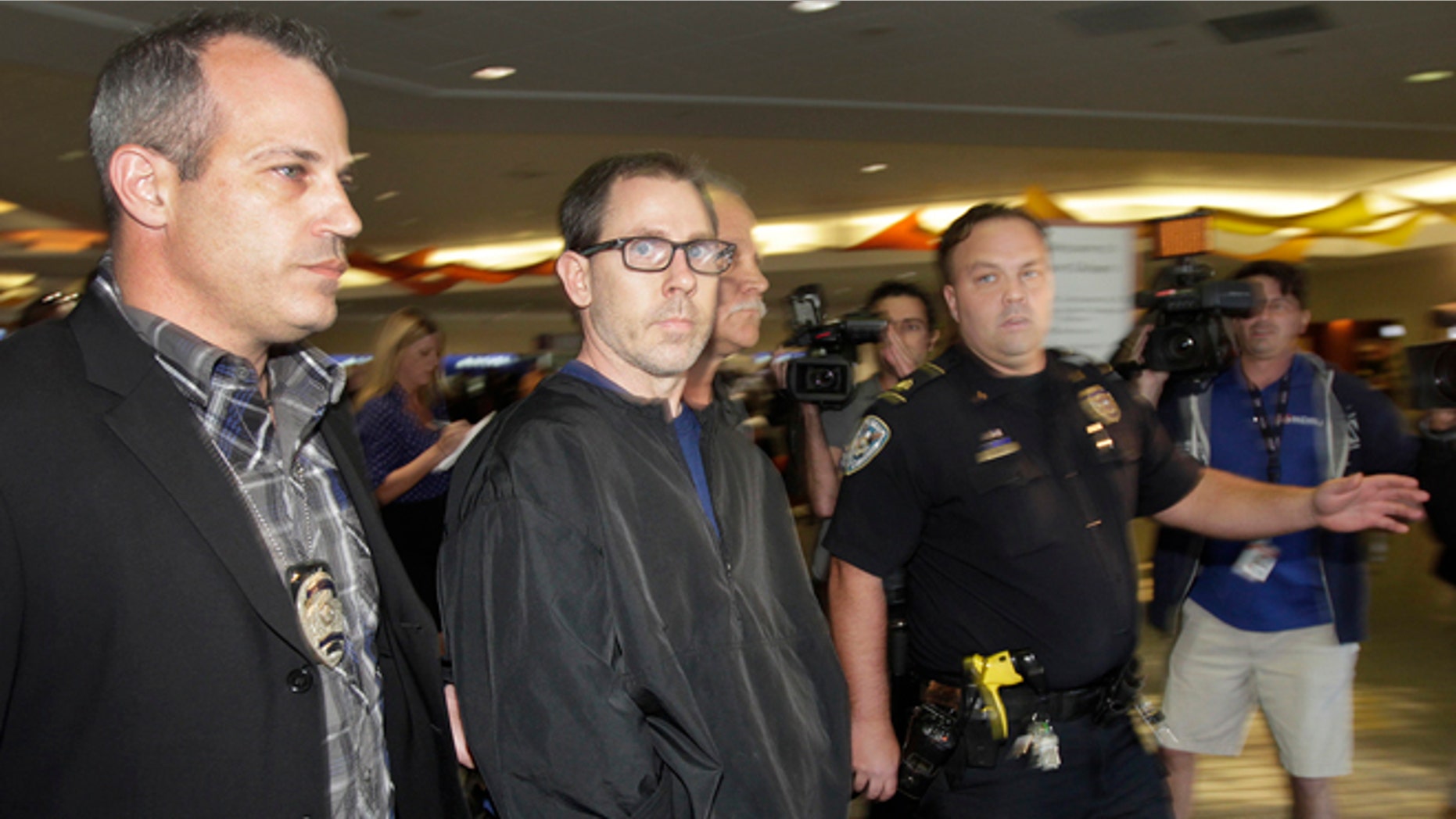 FILE - In a Oct. 15, 2014 file photo, Terry Speaks, center, a suspect in the 2012 stabbing and dismemberment of a Bourbon Street strip club dancer, arrives under heavy police guard at Louis Armstrong International Airport in Kenner, La. Trial is set to open Monday, June 15, 2015, for Speaks, accused of killing a New Orleans' French Quarter stripper in 2012, dismembering her and dumping body parts of the woman into the Gulf of Mexico. (Chris Granger/NOLA.com The Times-Picayune via AP, File) MAGS OUT; NO SALES; USA TODAY OUT; THE BATON ROUGE ADVOCATE OUT