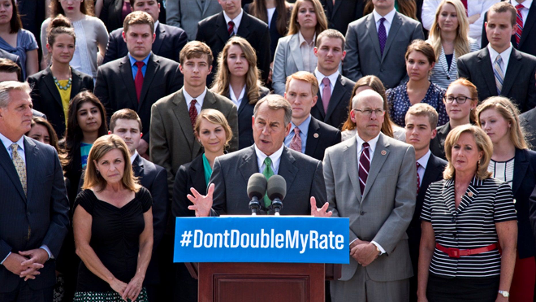 In this July 8, 2013, photo, with a backdrop of college students on the step of the House of Representatives, Speaker of the House John Boehner, R-Ohio, center, and GOP leaders talk about the politics of federal student loan rates which doubled on July 1, at the Capitol in Washington. (AP Photo/J. Scott Applewhite)