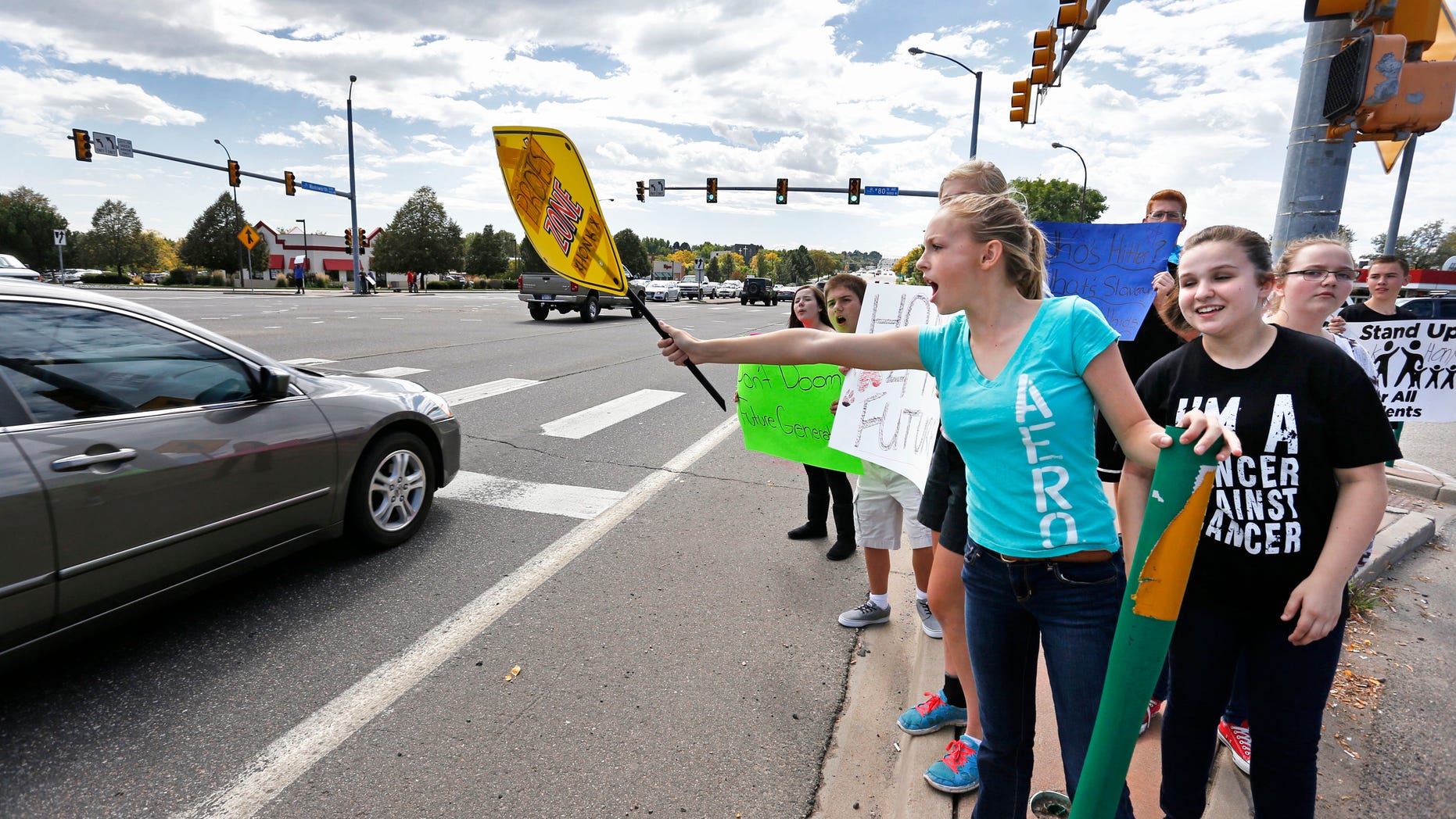 Sept. 23, 2014: Pamona High School students engage with passing motorists in a busy intersection near their school, during a multi-school protest against a Jefferson County School Board proposal to emphasize patriotism and downplay civil unrest in the teaching of U.S. history, in Arvada, Colo.