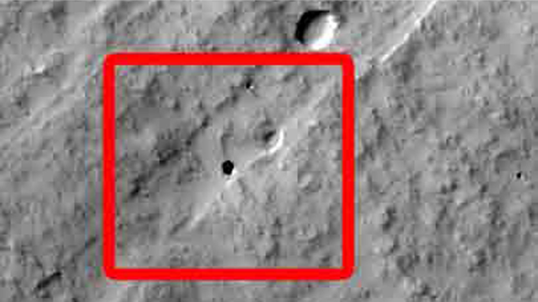 California 7th graders discovered this Martian pit feature at the center of the superimposed red square in this image while participating in a program that enables students to use the camera on NASA's Mars Odyssey orbiter. The feature, on the slope of an equatorial volcano named Pavonis Mons, appears to be a skylight in an underground lava tube.