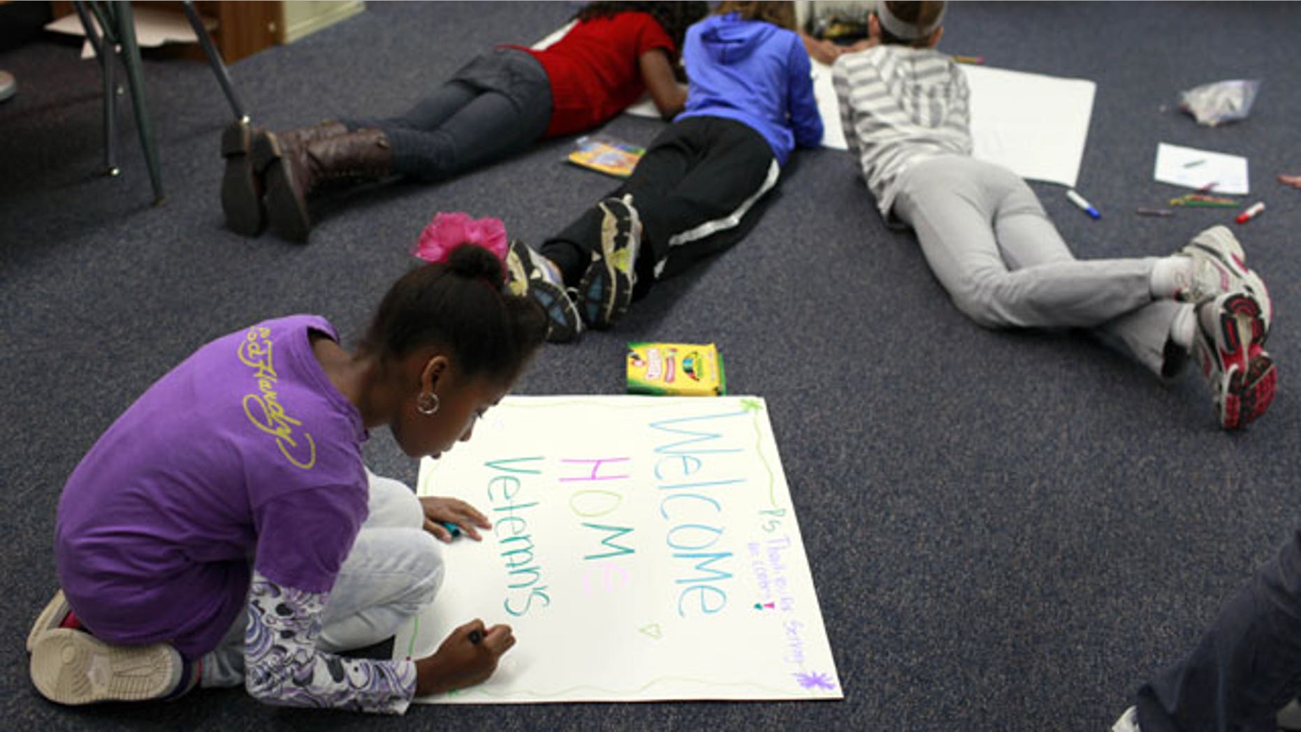 January 25, 2012: Niliah Banks, foreground, works with other students in her fifth grade class at Ross Elementary create hand-made signs in Creve Coeur, Mo. The signs will be used when St. Louis hosts a "Welcome Home the Heroes from Iraq Day" on Jan. 28.
