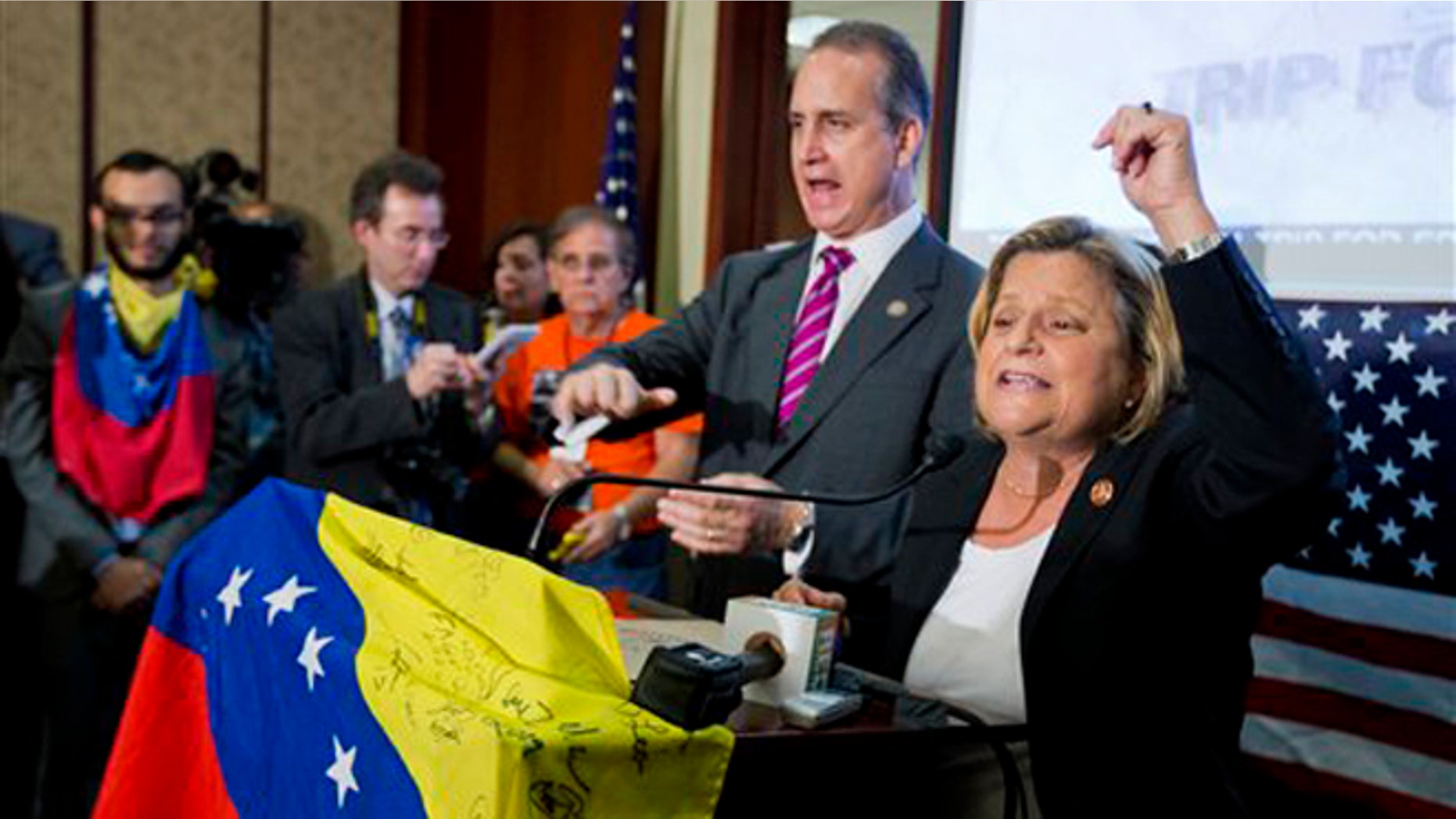 Rep. Ileana Ros-Lehtinen, R-Fla., right, and Rep. Mario Diaz-Balart, R-Fla., join Venezuelan-Americans gathered on Capitol Hill in Washington, Friday, May 9, 2014, to pressure the Obama administration to implement sanctions on the regime of Nicolas Maduro, the president of Venezuela. (AP Photo/Manuel Balce Ceneta)
