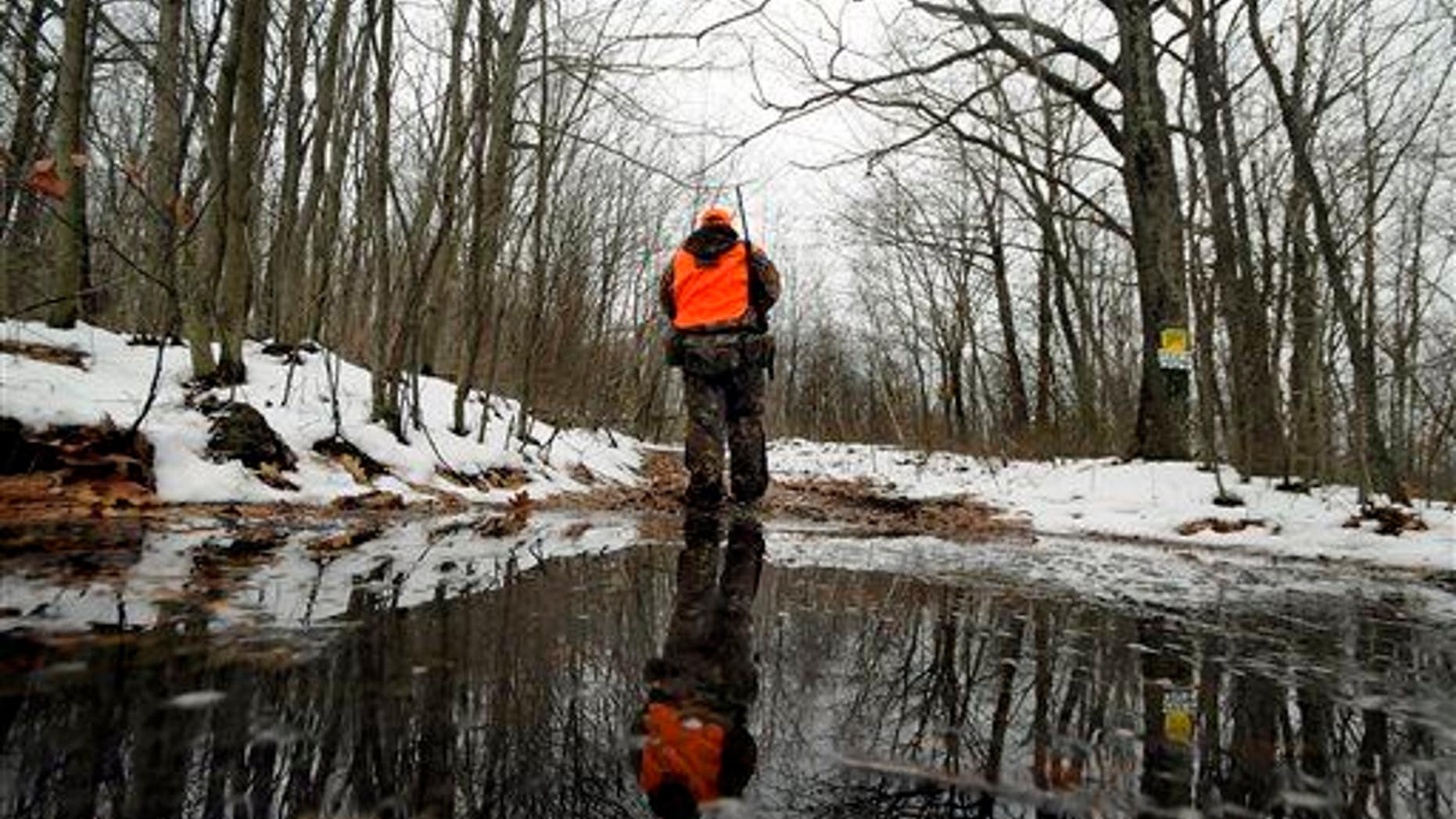 Hunter Brian Doherty of Jessup, Pa., begins his trek into the woods at Jessup Mountain on Monday, Dec. 1, 2014.