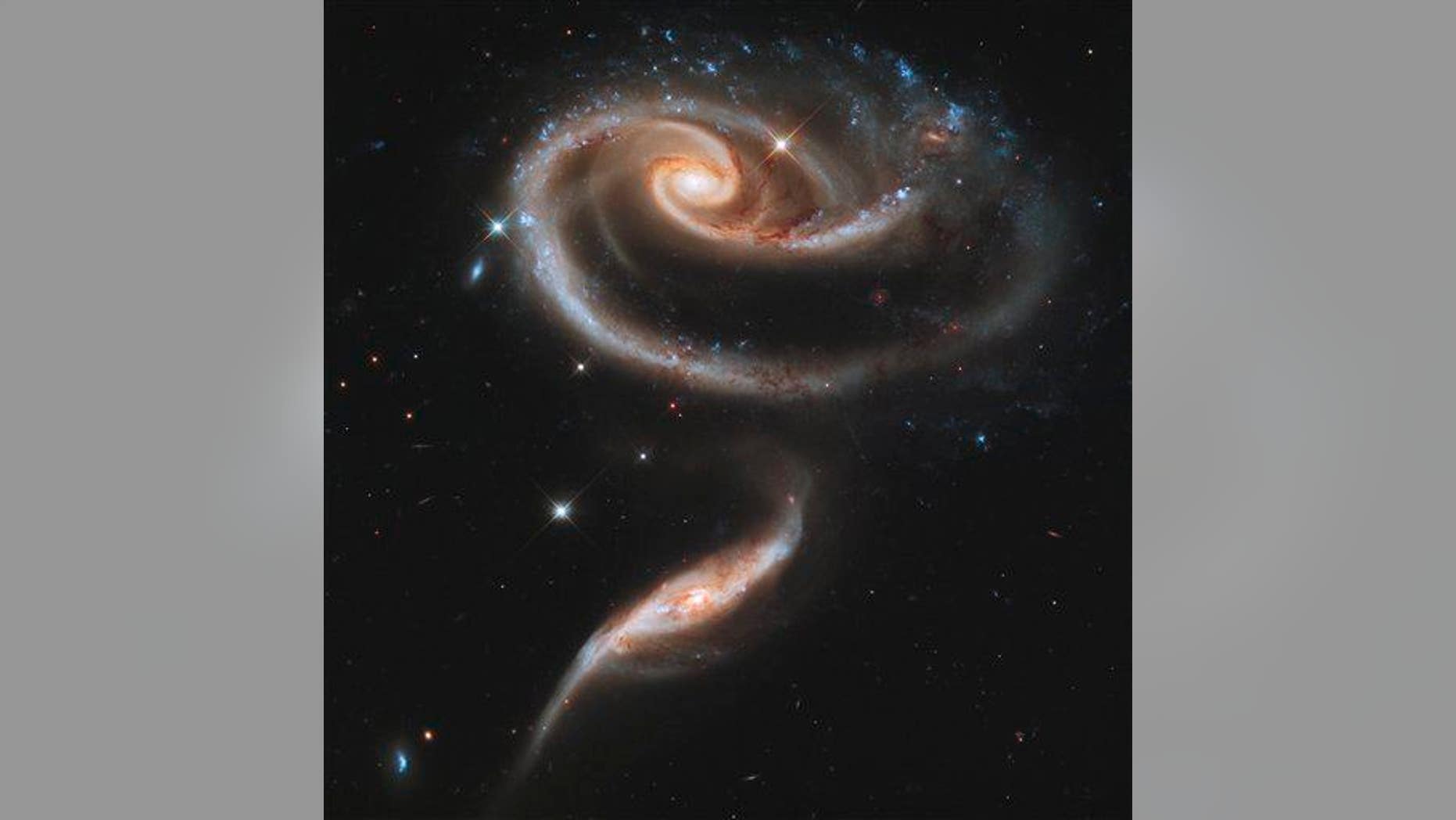 In this image provided April 20, 2011, by NASA, the Hubble Space Telescope photographed an especially photogenic group of interacting galaxies called Arp 273.