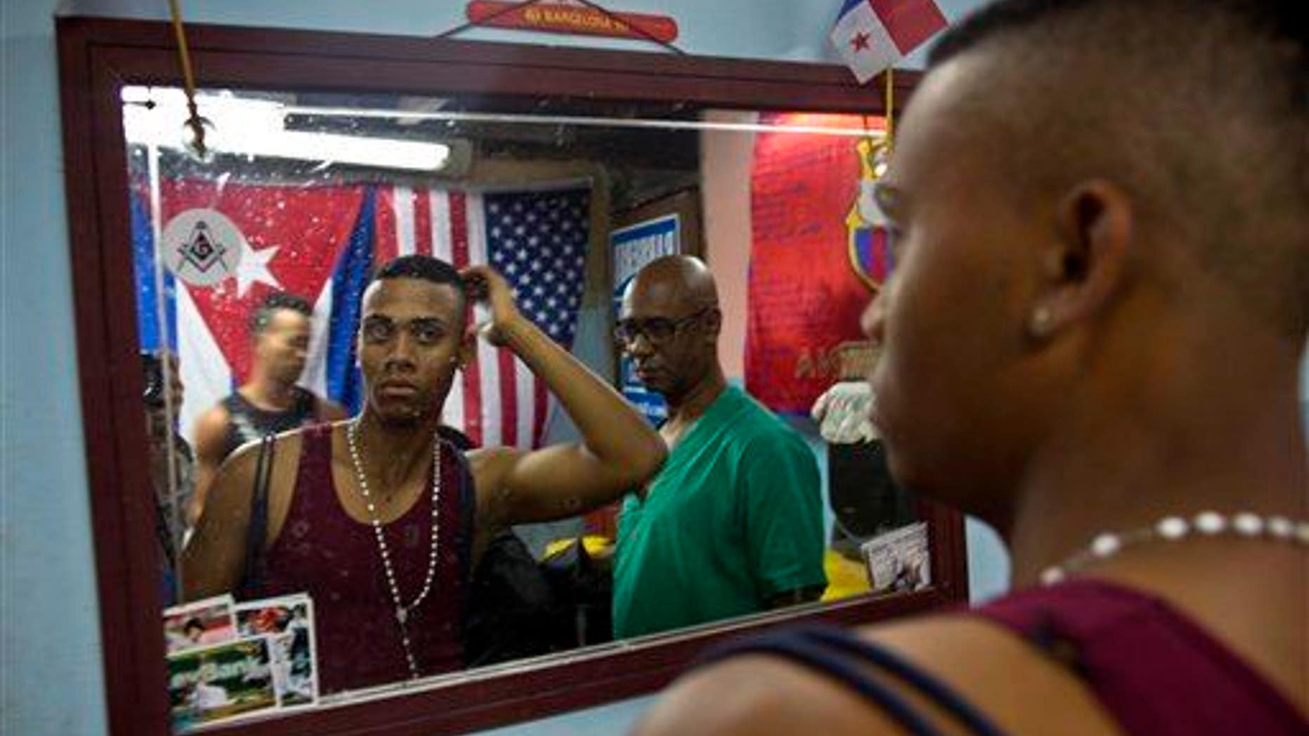 A client looks in the mirror in Havana, Feb. 27, 2015.