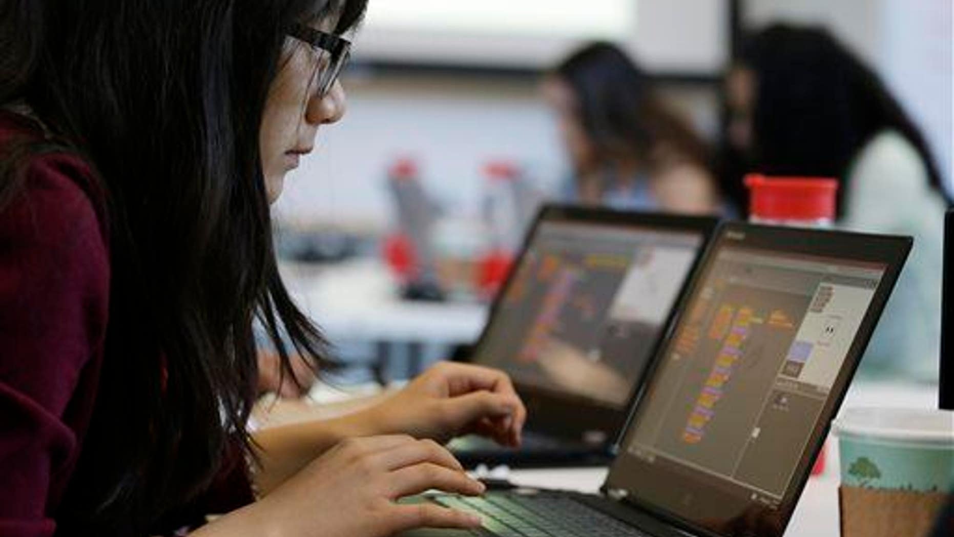 In this photo taken June 18, 2014, a teen works on completing an exercise during a "Girls Who Code" class at Adobe Systems in San Jose, Calif.