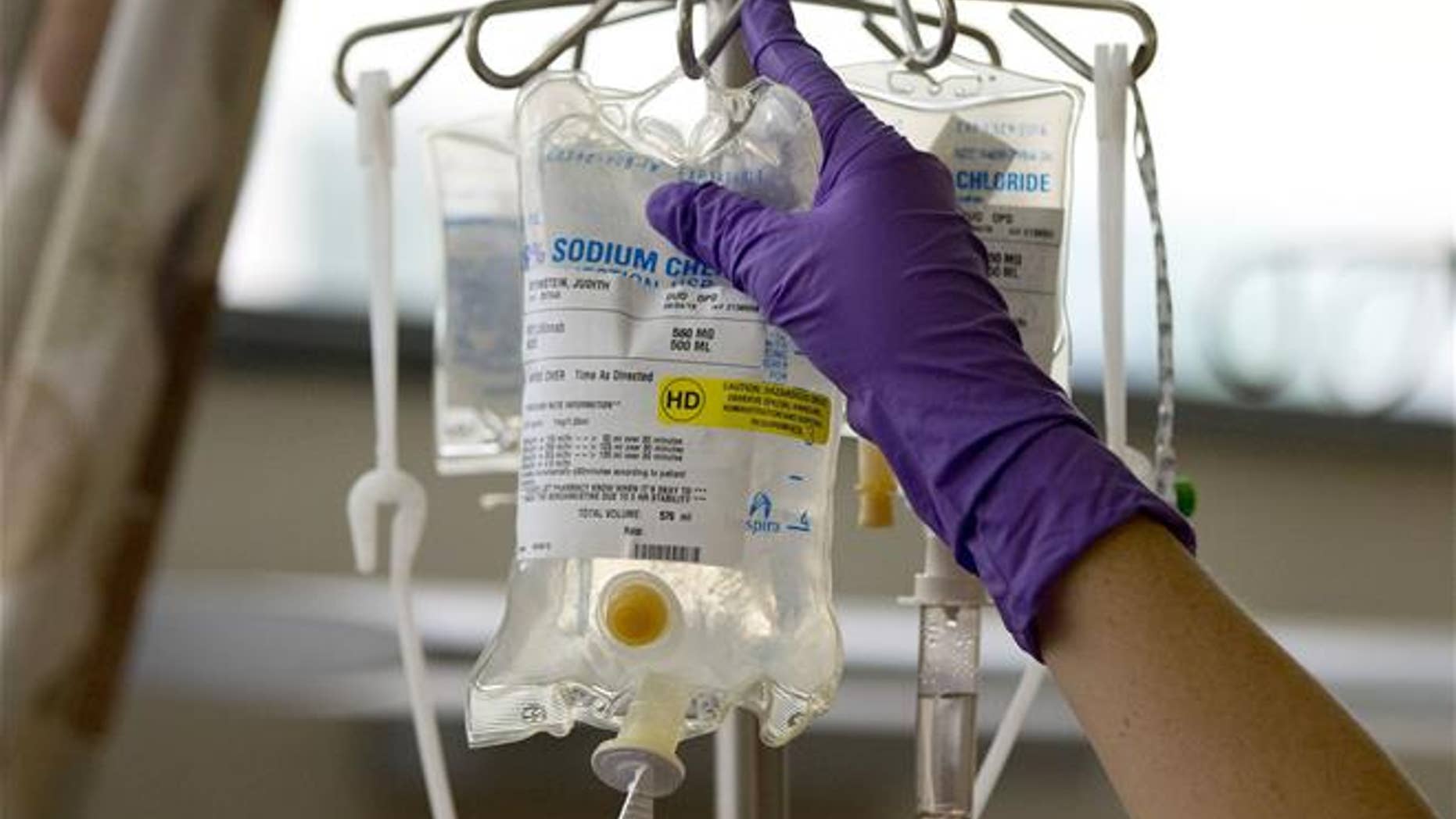 In this Aug. 4, 2015, file photo, a nurse places a patient's chemotherapy medication on an IV stand at a hospital in Philadelphia.