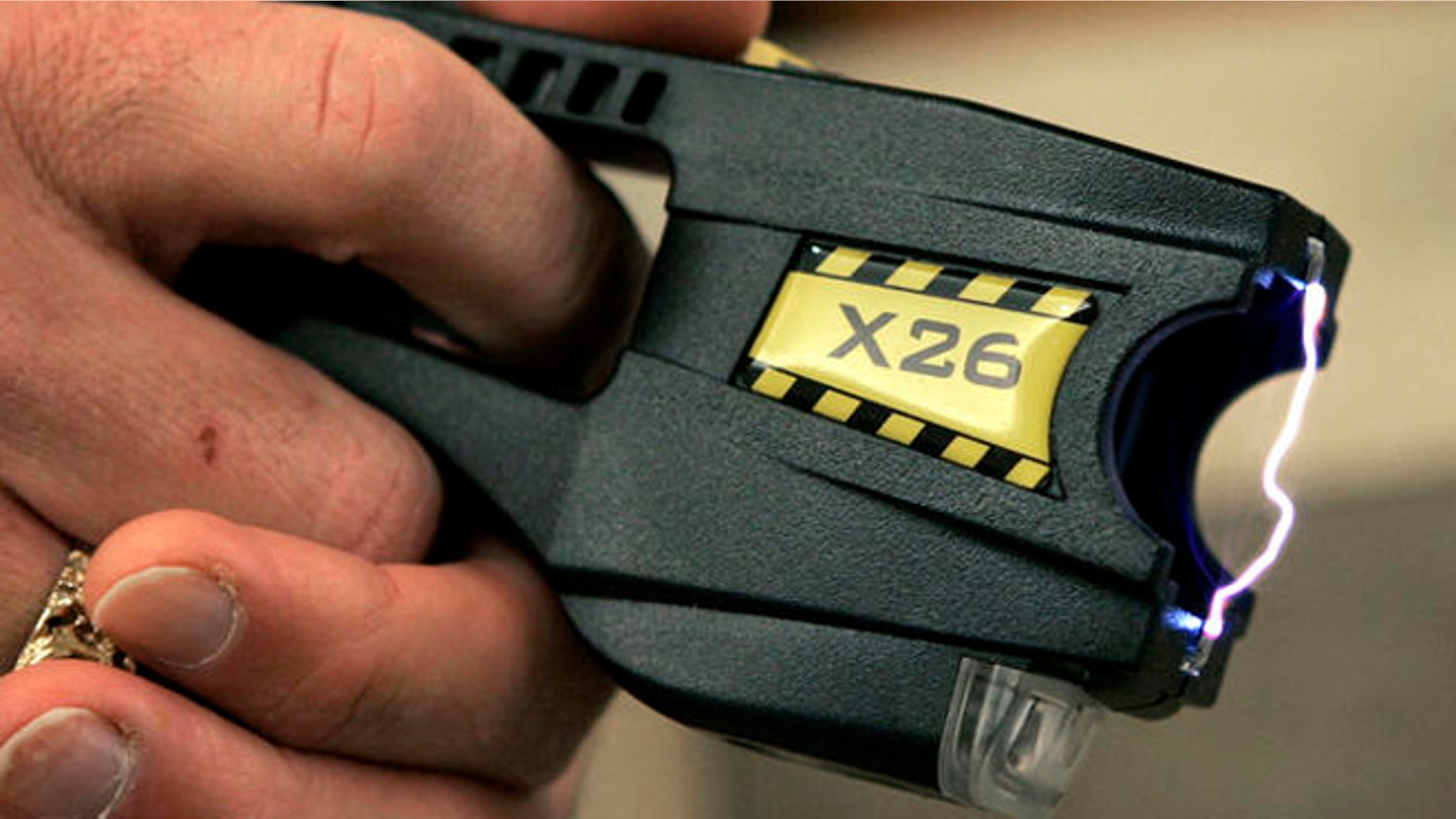 A Taser X26 stun gun is displayed at the Oakland Country Sheriff's office in Pontiac, Mich., Tuesday, Dec. 12, 2006. A little-noticed bill that would let more people use Tasers and stun guns in Michigan is awaiting Gov. Jennifer Granholm's signature, though critics hope she wields her veto pen. The legislation approved by the state Senate 30-7 last week would exempt detention facilities and private security officers at some hospitals and malls from a ban against Tasers, which have been criticized for causing deaths. (AP Photo/Carlos Osorio)