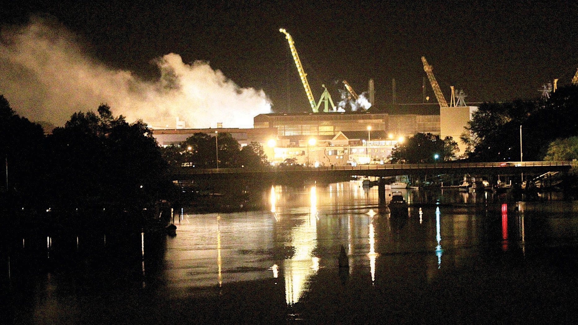 May 23, 2012: Smoke rises from a dry dock as fire crews respond Wednesday, to a fire on the USS Miami.