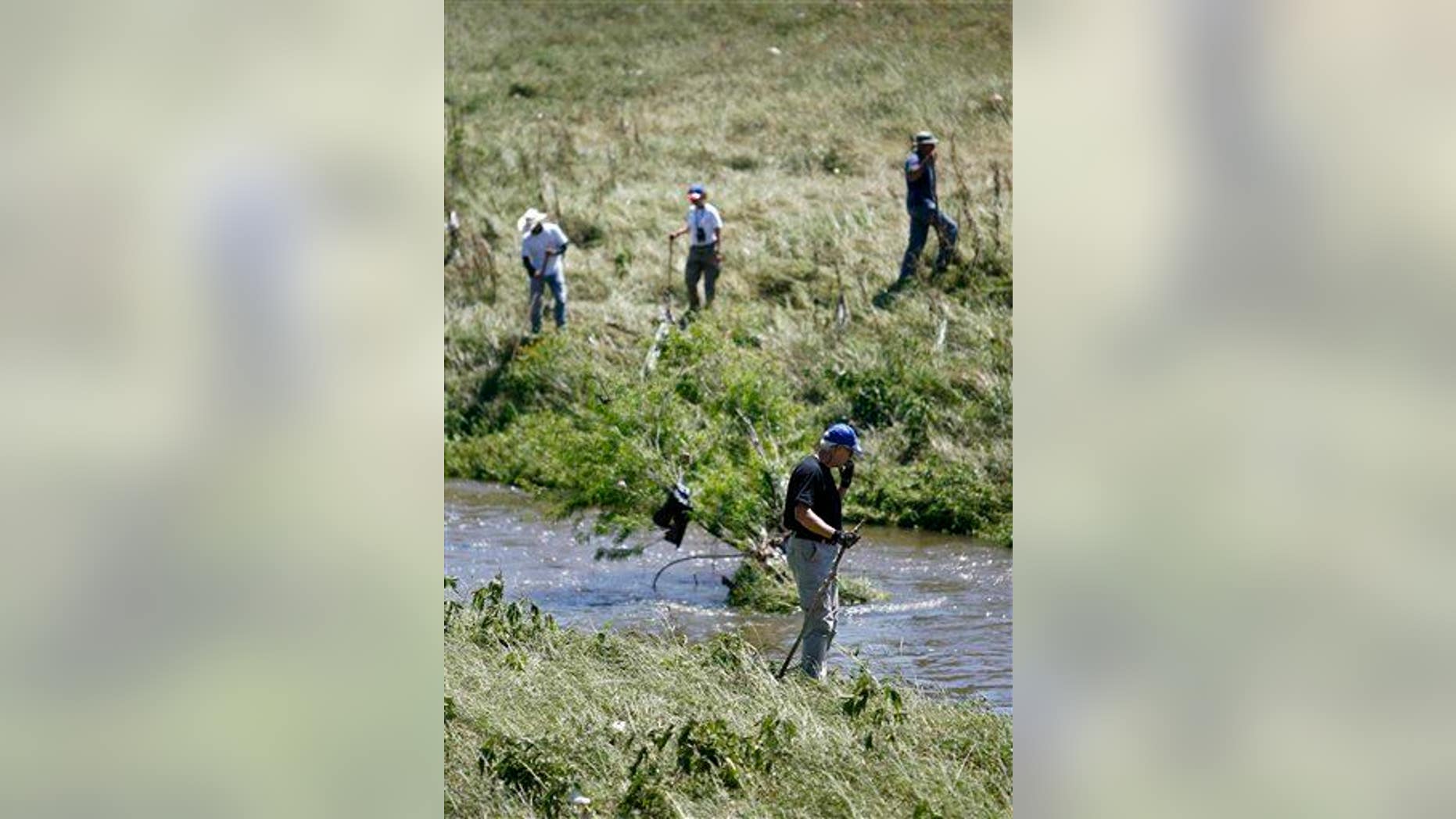 Members of Texas Equusearch along the banks of Greens Bayou in Houston looking for a child killed in a car accident in 2009.