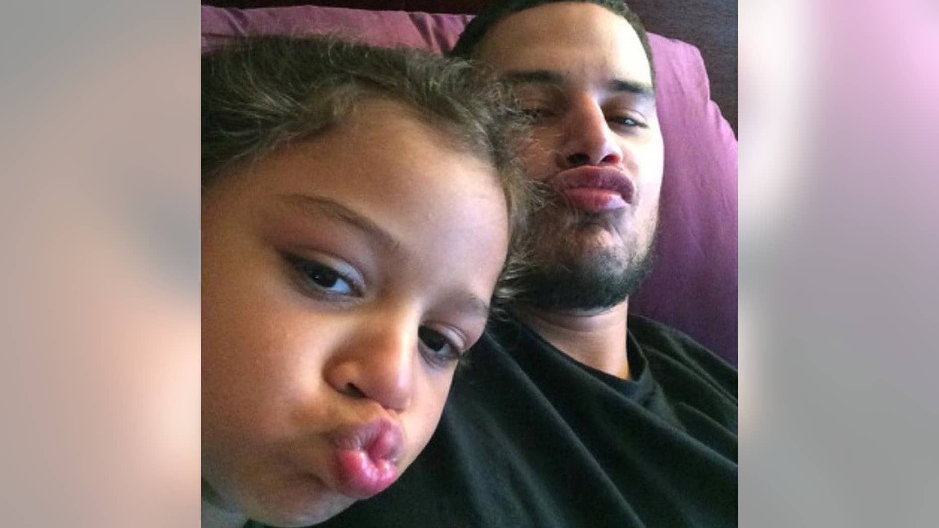 In this undated photo provided by Elizabeth Arroyo, construction worker Gilterto Drogheo sits with his young daughter, Gia, in New York. On March 10, 2010, Drogheo was shot and killed in New York by William Groomes, a 69-year-old retired jail guard licensed to carry a concealed weapon. Groomes claimed he was trying to arrest Drogheo for assault. (Gilterto Drogheo/Elizabeth Arroyo via AP)