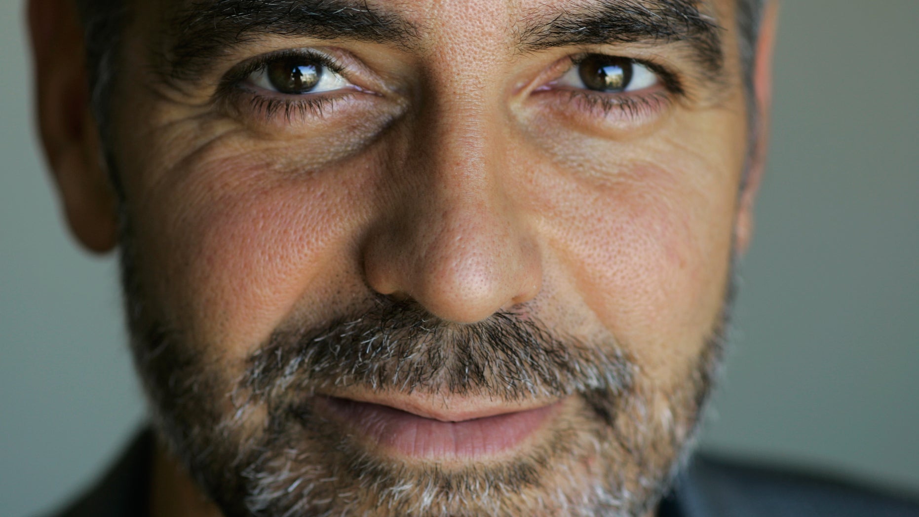 In this 2007 file photo, George Clooney poses for a portrait during the Toronto International Film Festival. A group founded by Clooney said Dec. 28 it teamed up with Google, a U.N. agency and anti-genocide organizations to launch satellite surveillance of the border between north and south Sudan to try to prevent a new civil war.
