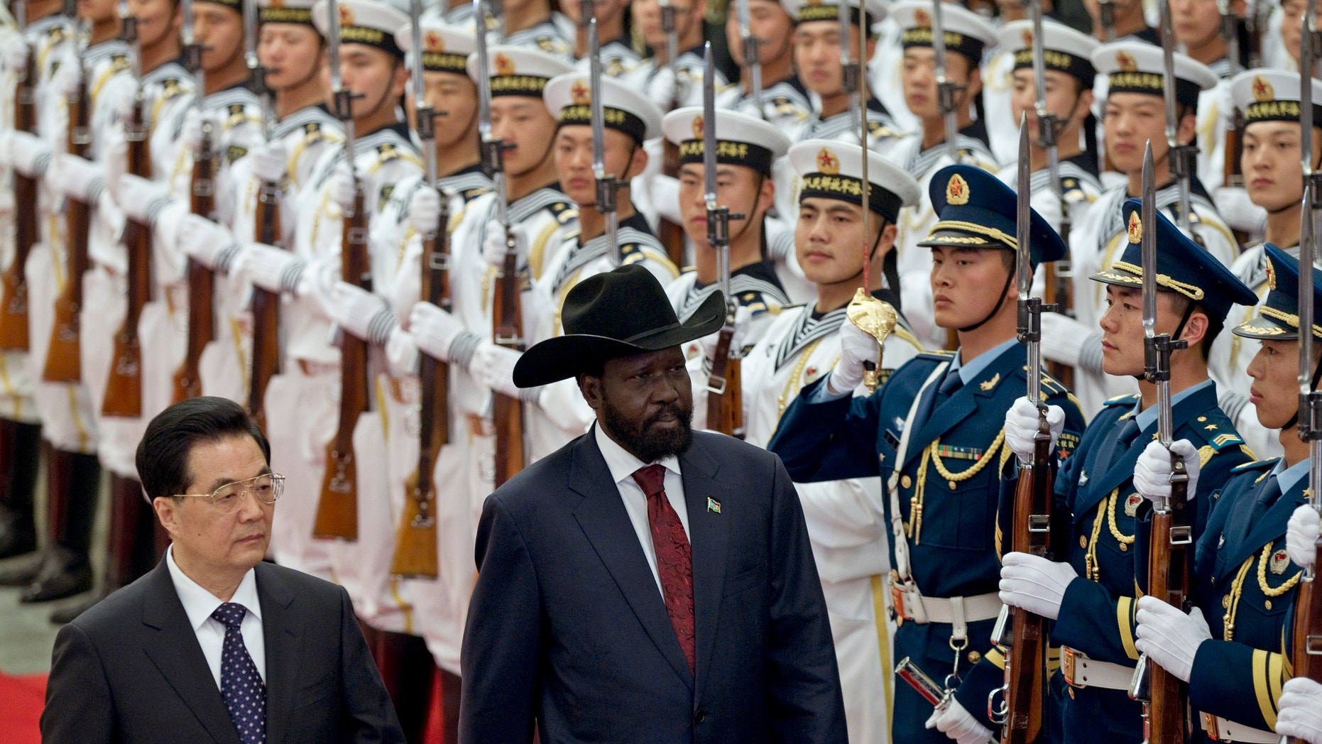 April 24, 2012: South Sudan's President Salva Kiir, right, reviews honor guard with Chinese President Hu Jintao, left, during a welcoming ceremony at the Great Hall of the People.