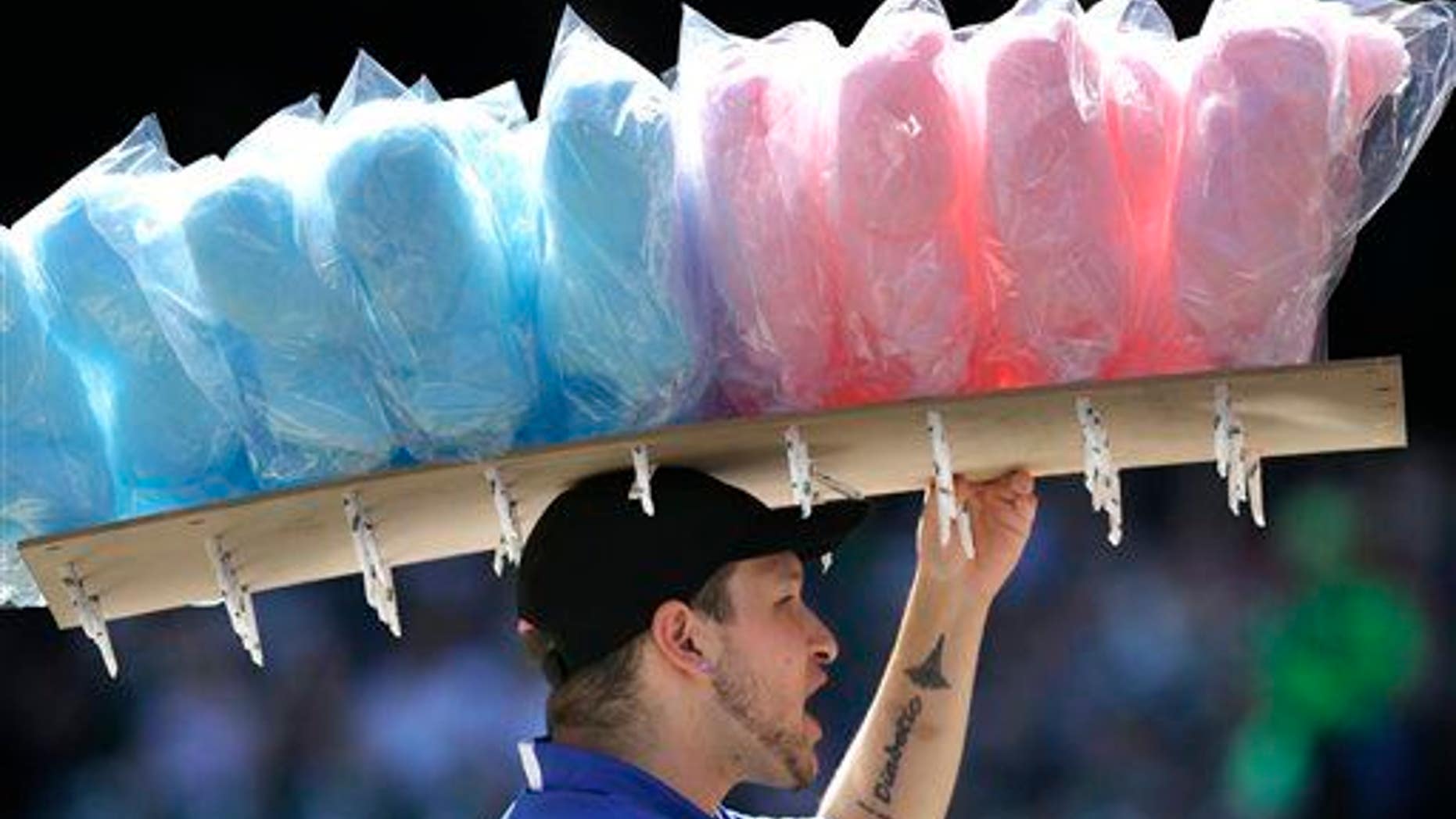 In this Sept. 8, 2013, file photo, a vendor sells cotton candy at Safeco Field during a baseball game between the Tampa Bay Rays and the Seattle Mariners, in Seattle.