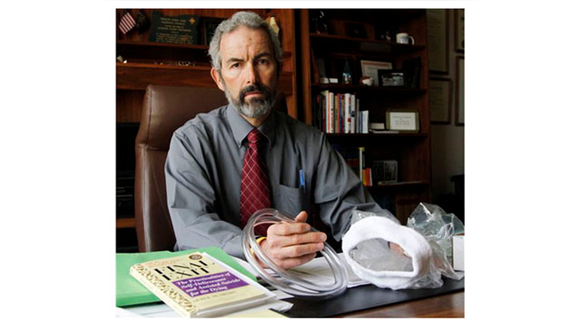 May 12: Oregon State Sen. Floyd Prozanski shows a suicide kit consisting of the book "Final Exit", plastic tubing and a plastic bag with collar that fits over a person's head at his Capitol office in Salem, Ore.