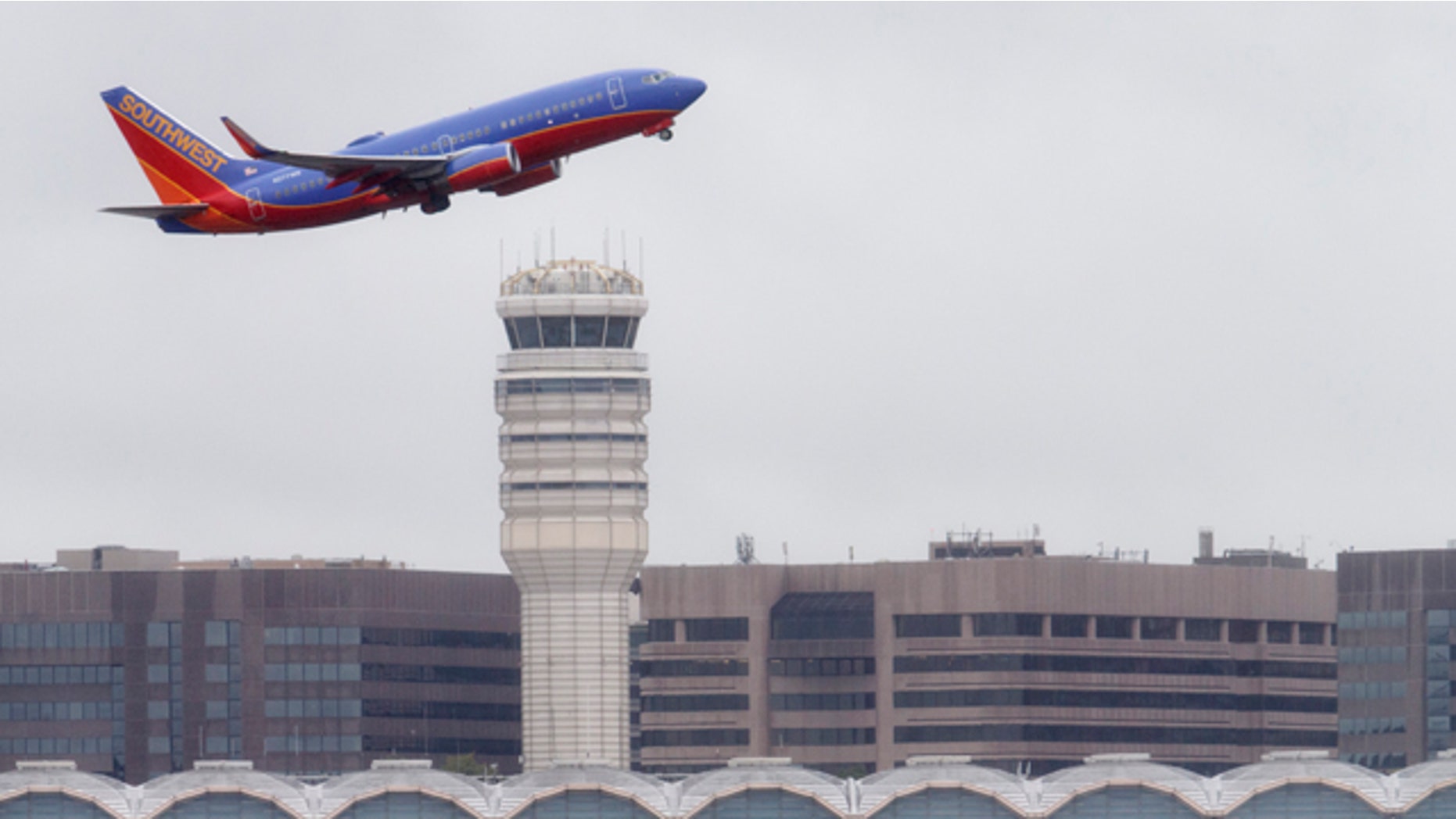 FILE - In this Sept. 25, 2014 file photo, a Southwest Airlines jet takes off from Washington's Ronald Reagan National Airport. (AP Photo/J. Scott Applewhite, File)