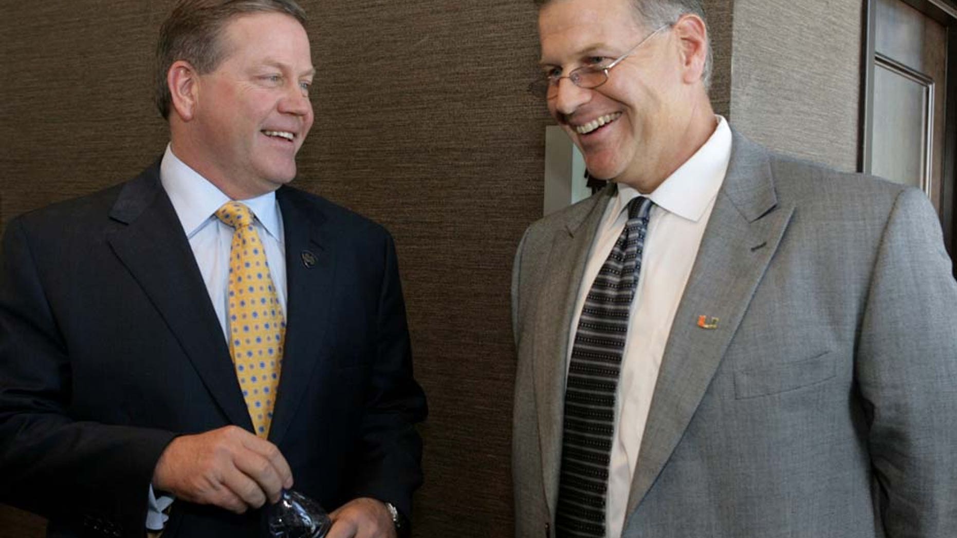 Notre Dame head coach Brian Kelly and University of Miami head coach Jeff Stoutland share a moment before the start of the coaches luncheon that kicked off activities for the upcoming 77th Annual Hyundai Sun Bowl. Both coaches were in El Paso to meet with members of the media as well as scout where the two teams will be lodging and practicing while in El Paso for the December 31st, New Years Eve game. Ruben R Ramirez/EL Paso Times