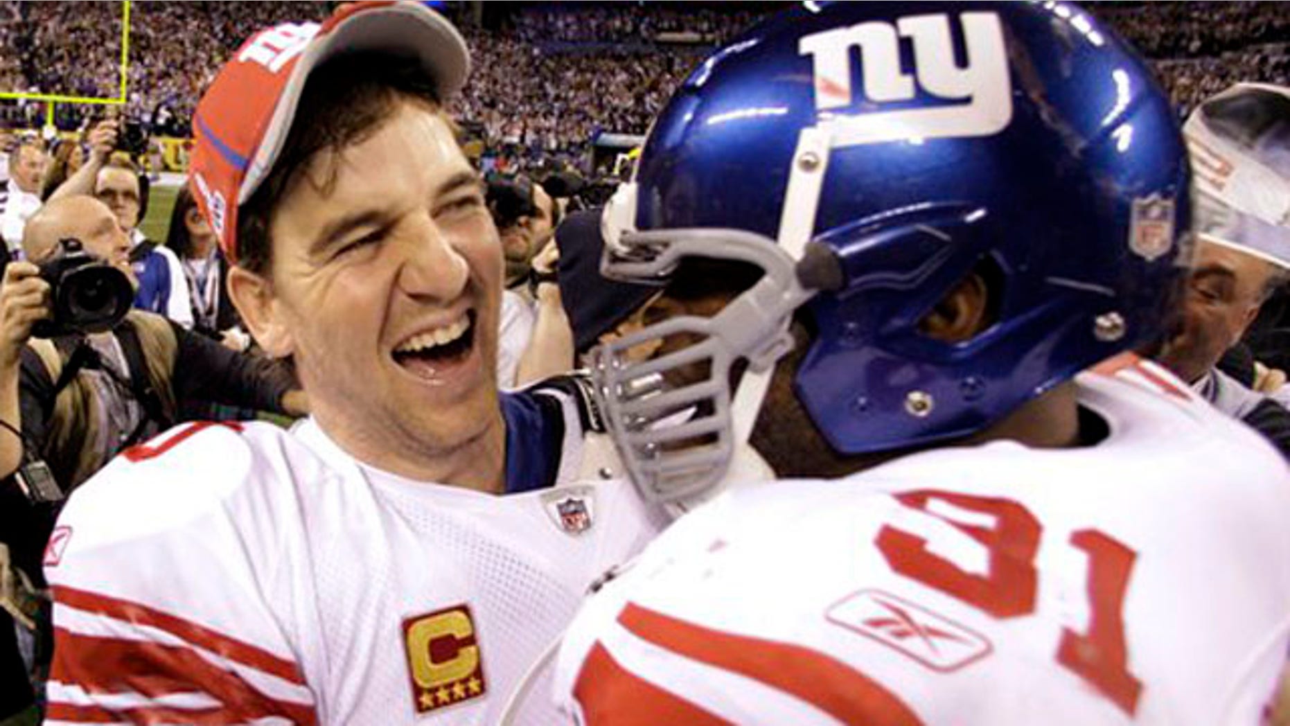 Feb. 5, 2012: New York Giants quarterback Eli Manning, left, and Aaron Ross celebrate their team's 21-17 win.