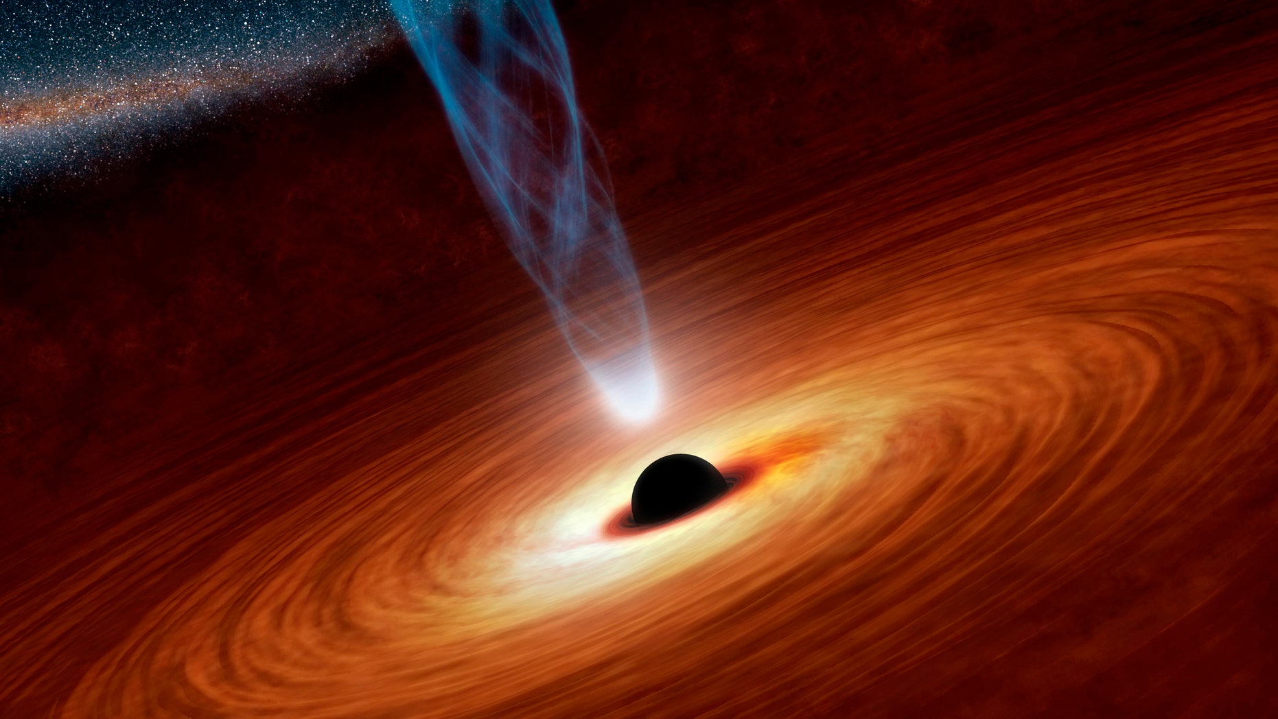 An artist's illustration shows a supermassive black hole with millions to billions times the mass of our sun at the center, surrounded by matter flowing onto the black hole in what is termed an accretion disk in this NASA illustration released on Feb. 27, 2013.