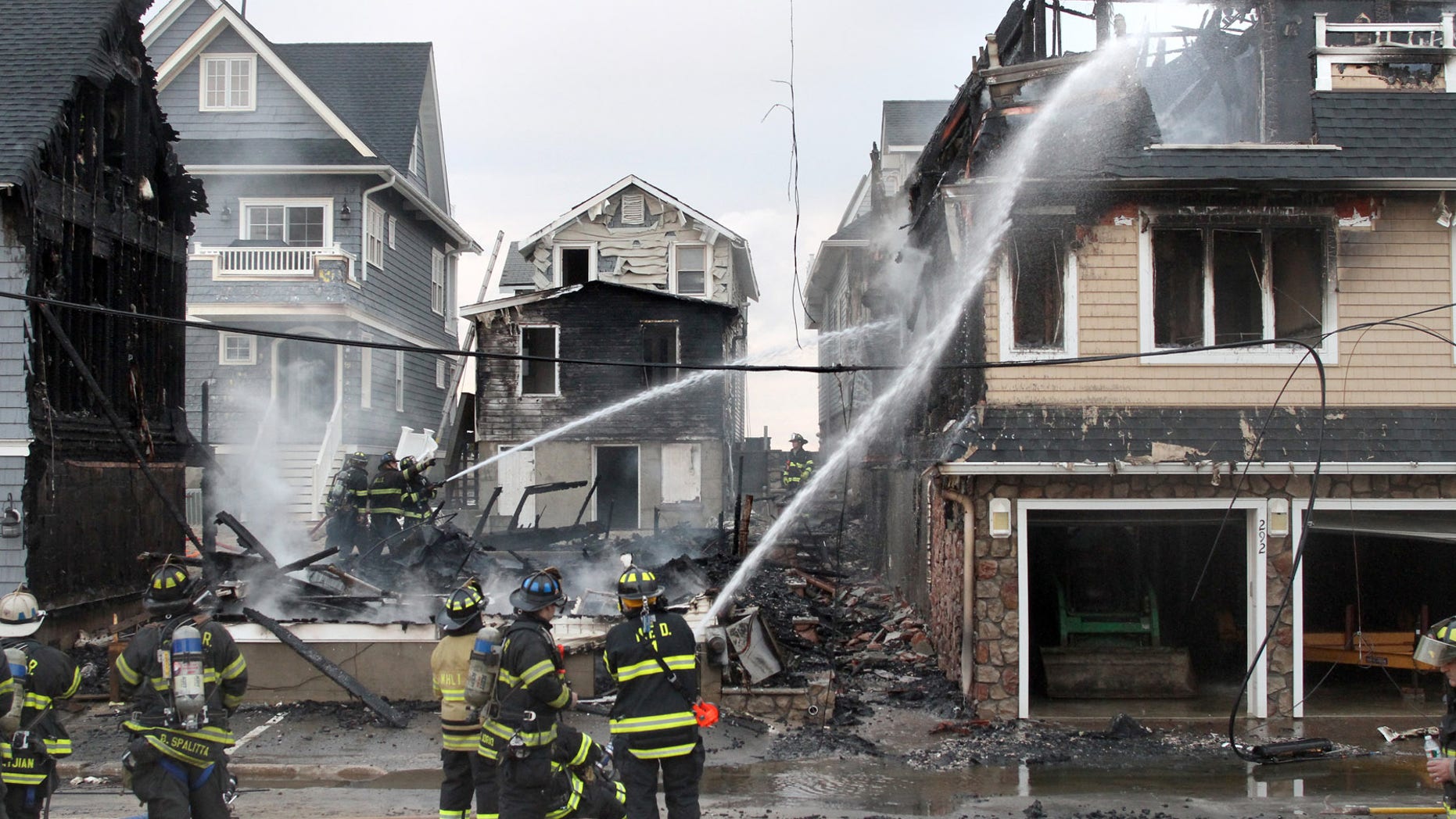 Dec. 5, 2012: Manasquan Firefighters work on the scene of a multi house fire on First Avenue on the beachfront in Manasquan, N.J.
