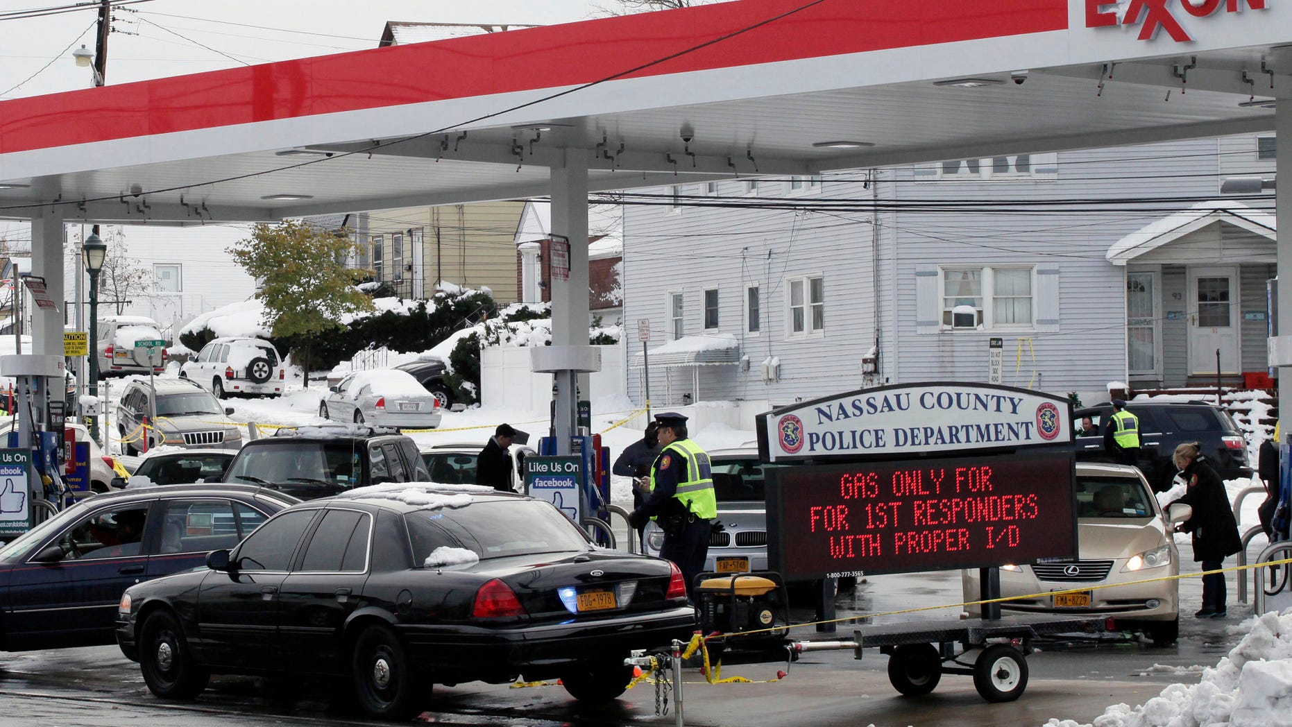 Nov. 8, 2012: Nassau County Police control access to an Exxon station in Elmont, N.Y. Gasoline supplies have been limited in the region since Superstorm Sandy hit ten days ago. The police are limiting sales of gasoline at this Long Island station to first responders.