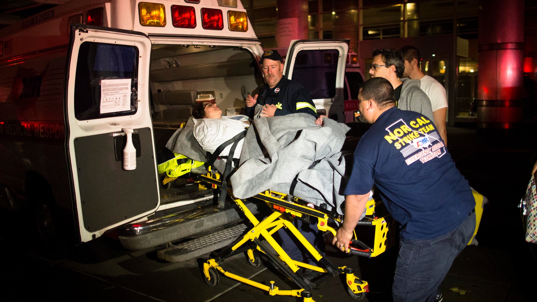Medical workers assist a patient into an ambulance during an evacuation of New York University Tisch Hospital, after its backup generator failed when the power was knocked out by a superstorm, Monday, Oct. 29, 2012, in New York. Dozens of ambulances lined up outside NYU Tisch Hospital on Monday night as doctors and nurses began the slow process of taking people out. (AP Photo/John Minchillo)