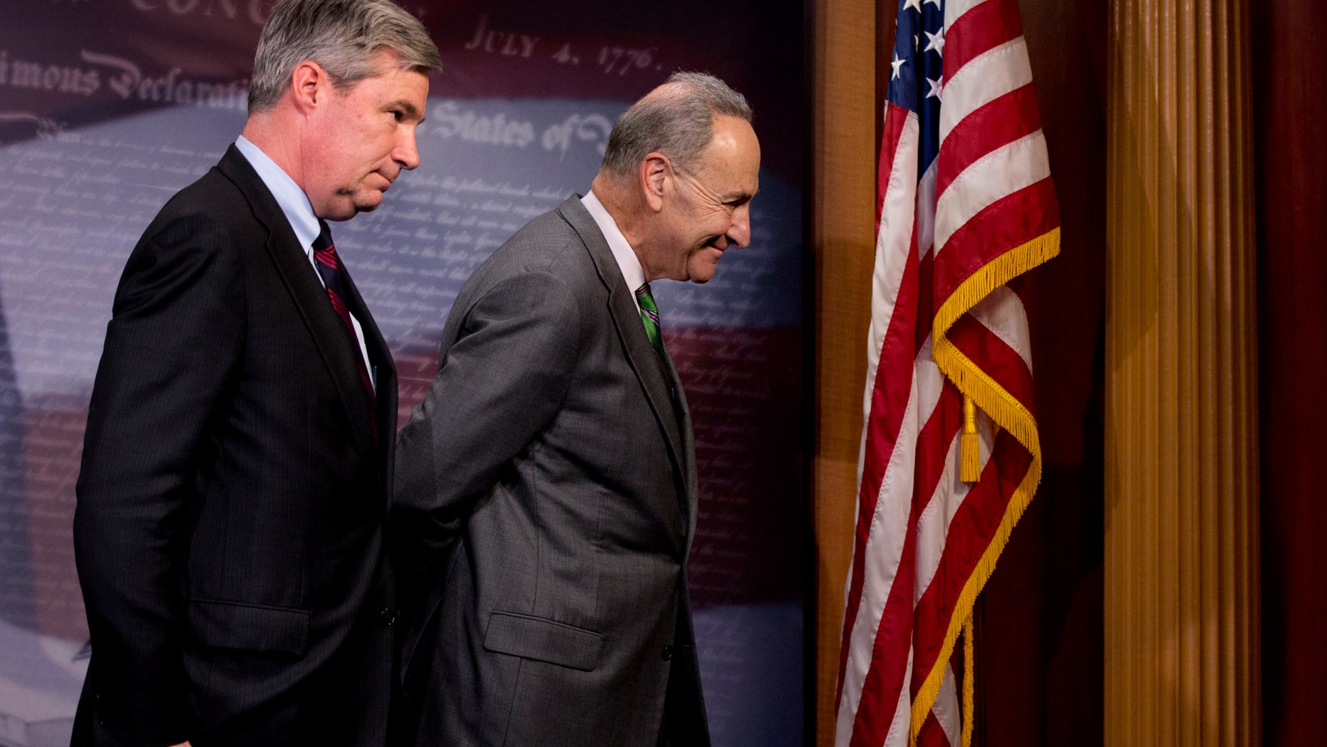 Sen. Charles Schumer and Sen. Sheldon Whitehouse leave a news conference on Capitol Hill, Wednesday, April 2, 2014.