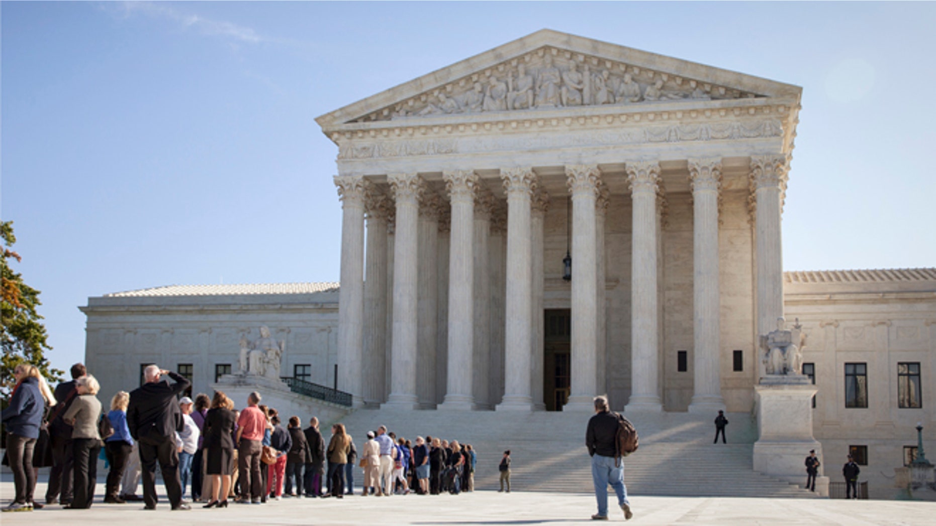 In this Monday, Oct. 6, 2014 photo, people wait to enter the Supreme Court in Washington as it begins its new term.