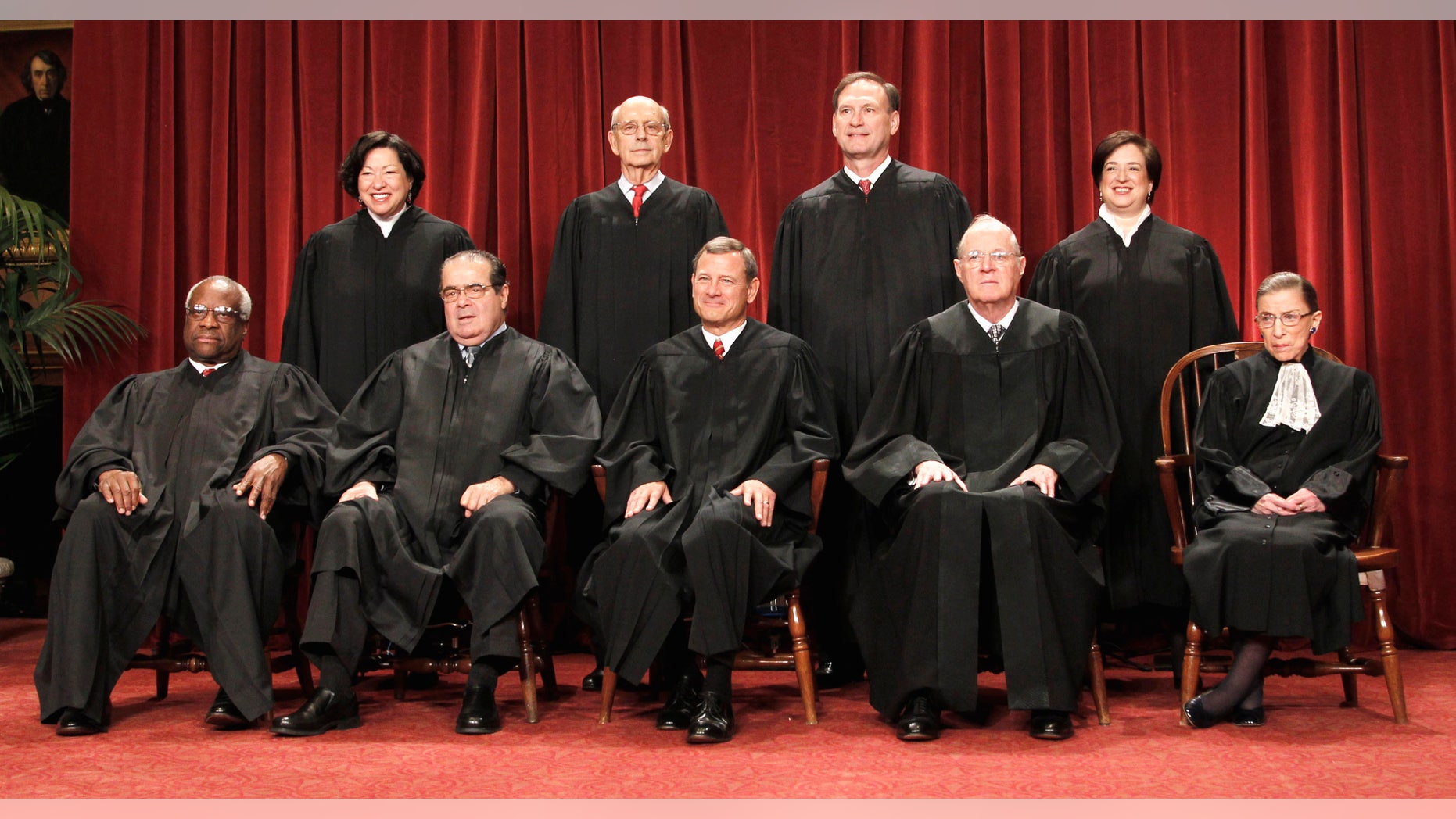 The justices of the U.S. Supreme Court at the Supreme Court in Washington. Seated from left are Associate Justices Clarence Thomas, and Antonin Scalia, Chief Justice John Roberts, Associate Justices Anthony M. Kennedy and Ruth Bader Ginsburg. Standing, from left are Associate Justices Sonia Sotomayor, Stephen Breyer, Samuel Alito Jr., and Elena Kagan.