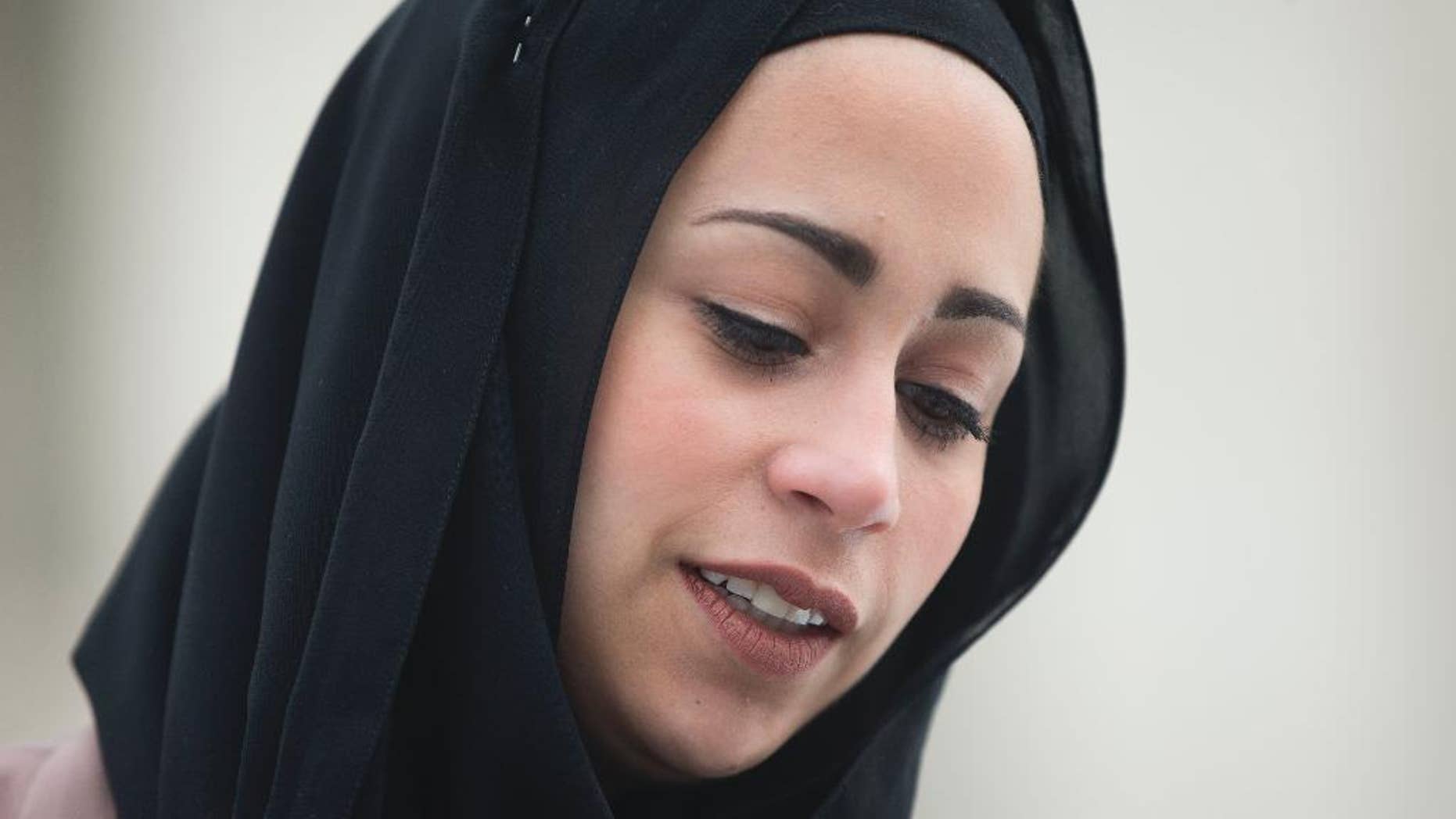 FILE - In this Feb. 25, 2015 file photo, Samantha Elauf stands outside the Supreme Court in Washington. he Supreme Court ruled Monday for a Muslim woman who did not get hired after she showed up to a job interview with clothing retailer Abercrombie & Fitch wearing a black headscarf. The justices said that employers generally have to accommodate job applicants and employees with religious needs if the employer at least has an idea that such accommodation is necessary. Job applicant Samantha Elauf did not tell her interviewer she was Muslim. (AP Photo/Pablo Martinez Monsivais, File)
