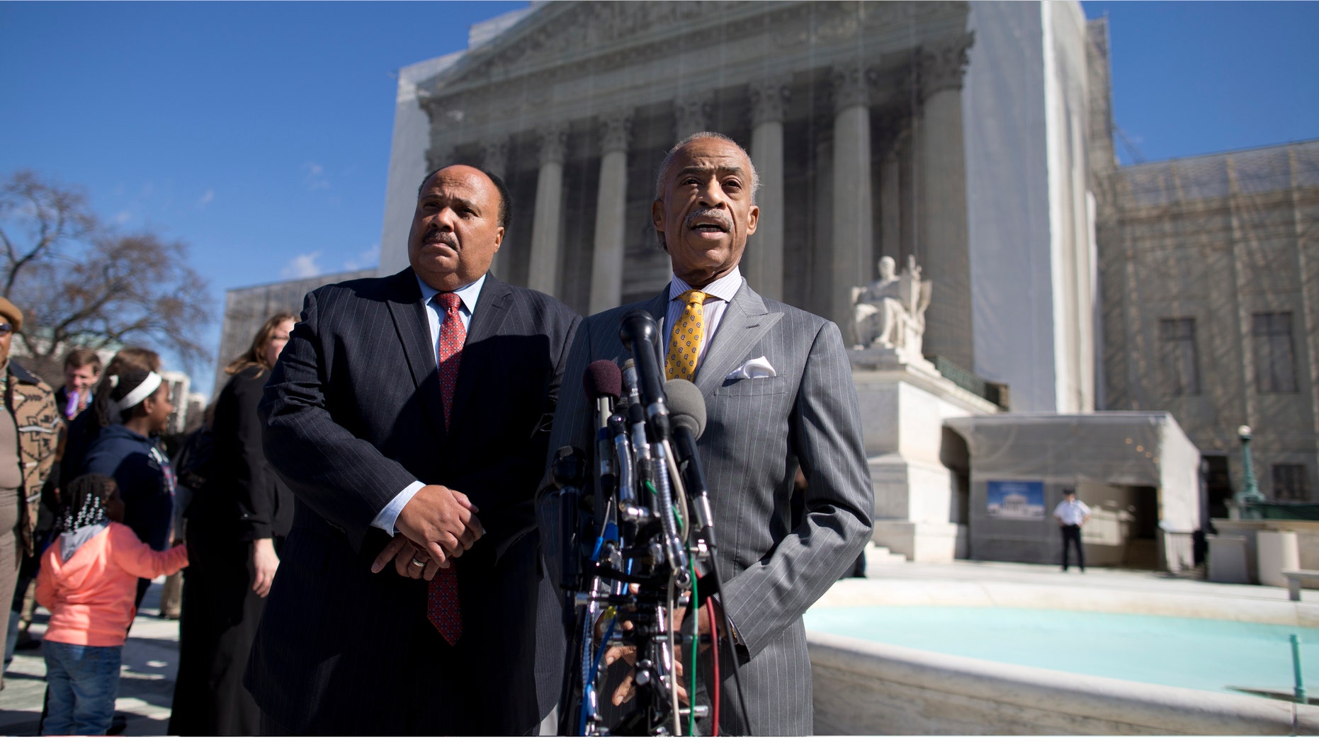 Rev. Al Sharpton, right, and Martin Luther King III meet with reporters outside the Supreme Court in Washington, Wednesday, Feb. 27, 2013, after arguments in the Shelby County, Ala., v. Holder voting rights case.