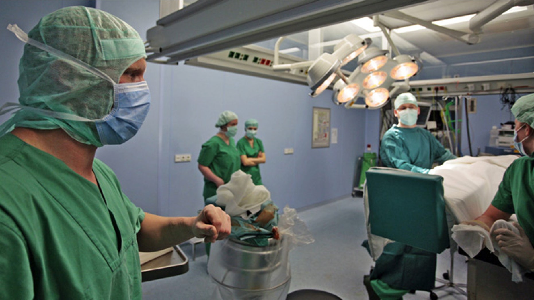 HALLE, GERMANY - APRIL 26: Josef Penzkofer (L.), specialist doctor for casualty surgery in the operations room in the clinic for surgery and orthopedics of the Martin Luther University April 26, 2006 in Halle, Germany. Clinic and hospital doctors throughout Germany have been striking periodically demanding higher pay and better working conditions. (Photo by Carsten Koall/ Getty Images)