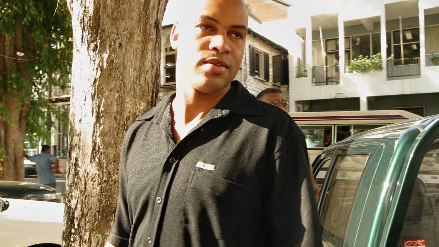FILE - In this Aug. 26, 2003 file photo, Dino Bouterse, son of Suriname President Desi Bouterse, arrives to a court hearing in Paramaribo, Suriname. Dino Bouterse received leniency Tuesday, March 10, 2015, from a judge who ordered him to serve over 16 years in prison, about half of the 30-to-life term the U.S. government sought after he admitted that he offered a home base in his South American country to the Lebanese militant group Hezbollah. (AP Photo/Edward Troon, File)