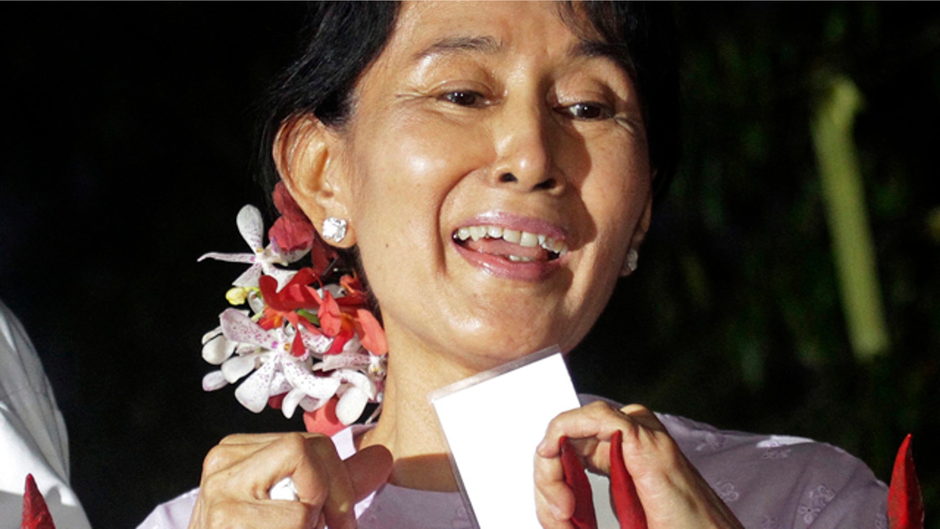 Nov. 13: Burma’s pro-democracy leader Aung San Suu Kyi talks to the supporters at the gates of her home after she was freed by the military junta.