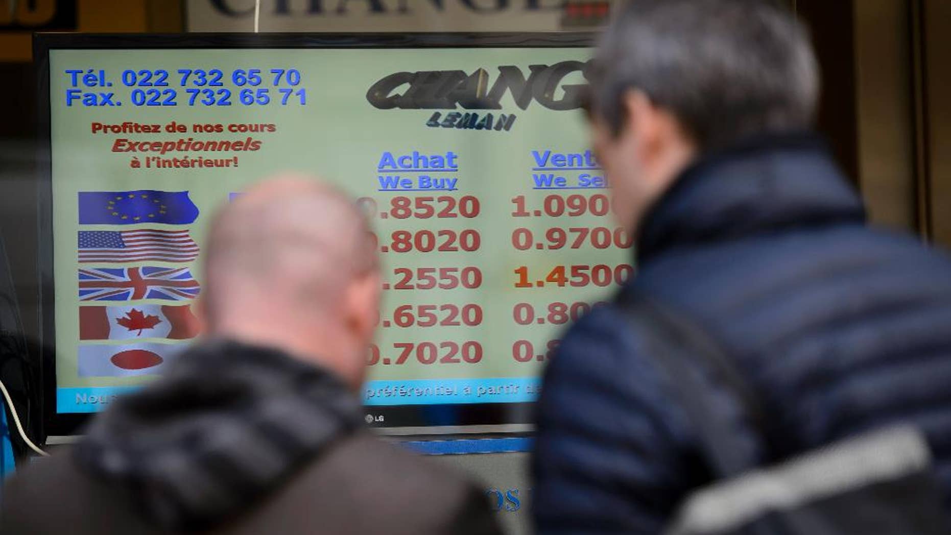 People line up at a currency exchange office, Thursday, Jan.15, 2015 in Geneva Switzerland. Switzerland's central bank said it has scrapped a policy that limited how much the euro could fall against the Swiss franc, an unexpected decision that caused gyrations in financial markets. The move to ditch the policy — which ensured the euro did not fall below 1.20 francs — sent the euro plummeting a stunning 30 percent against the Swiss currency before it recovered somewhat. By later morning, it was down 13 percent at 1.04 francs. (AP Photo/Keystone,Martial Trezzini)