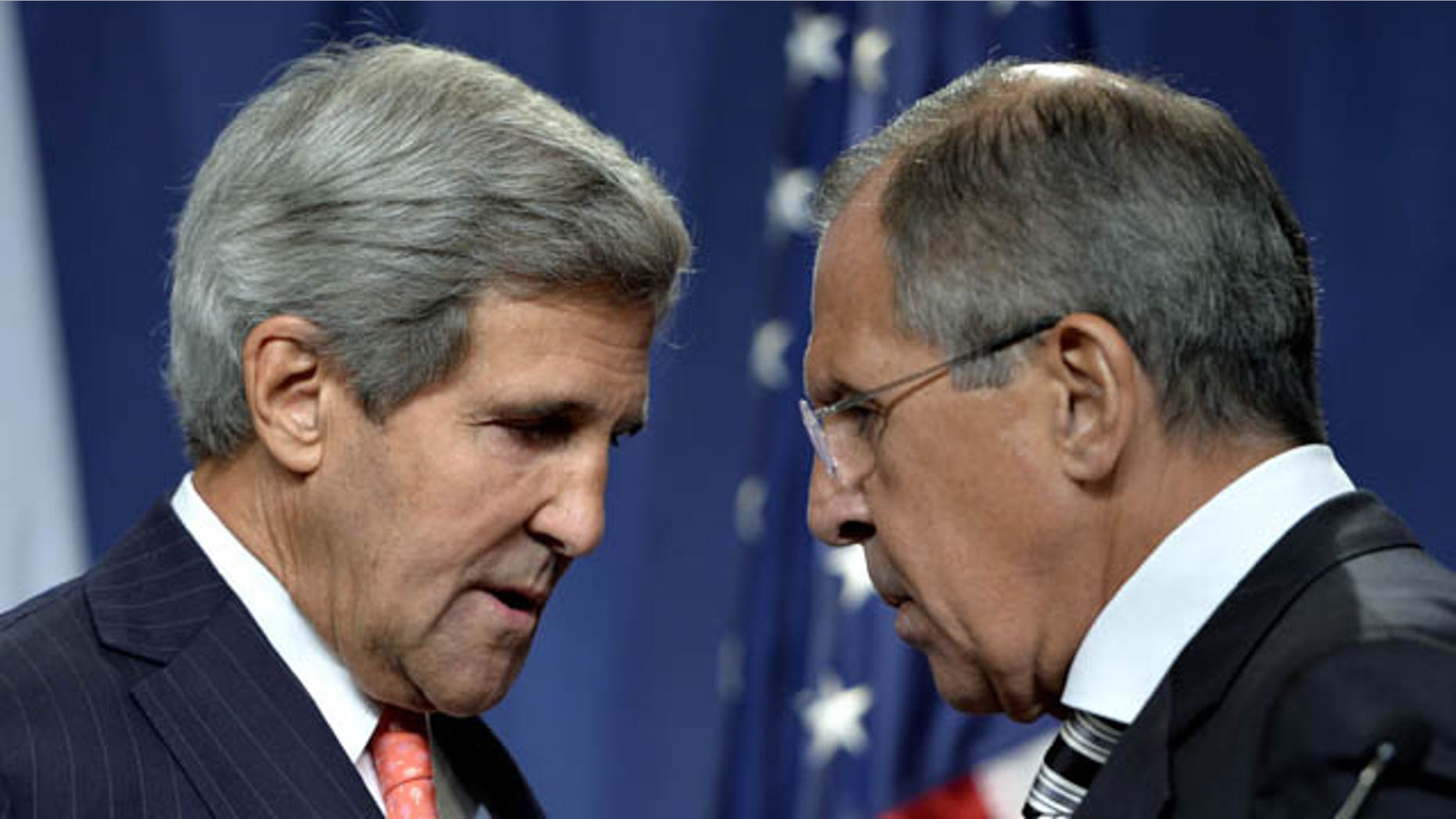 September 14, 2013: U.S. Secretary of State John Kerry, left, speaks with Russian Foreign Minister Sergei Lavrov, right, during a news conference in Geneva, Switzerland. (AP Photo/Keystone,Martial Trezzini)