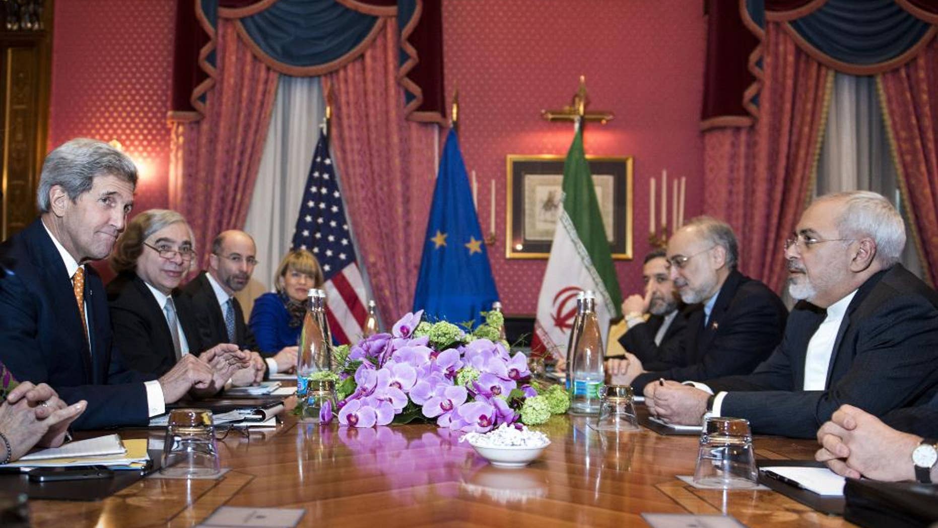 U.S. Secretary of State John Kerry, left, U.S. Secretary of Energy Ernest Moniz, second left, National Security Council point person on the Middle East Robert Malley, 3rd left, and European Union Political Director Helga Schmid. 4th left, head of the Iranian Atomic Energy Organisation Ali Akbar Salehi 2nd right, and Iranian Foreign Minister Mohammad Javad Zarif right wait for the start of a meeting at a hotel in Lausanne Switzerland on Thursday March 26, 2015 during negotiations on the Iranian nuclear programme. (AP Photo/Brendan Smialowski, Pool)