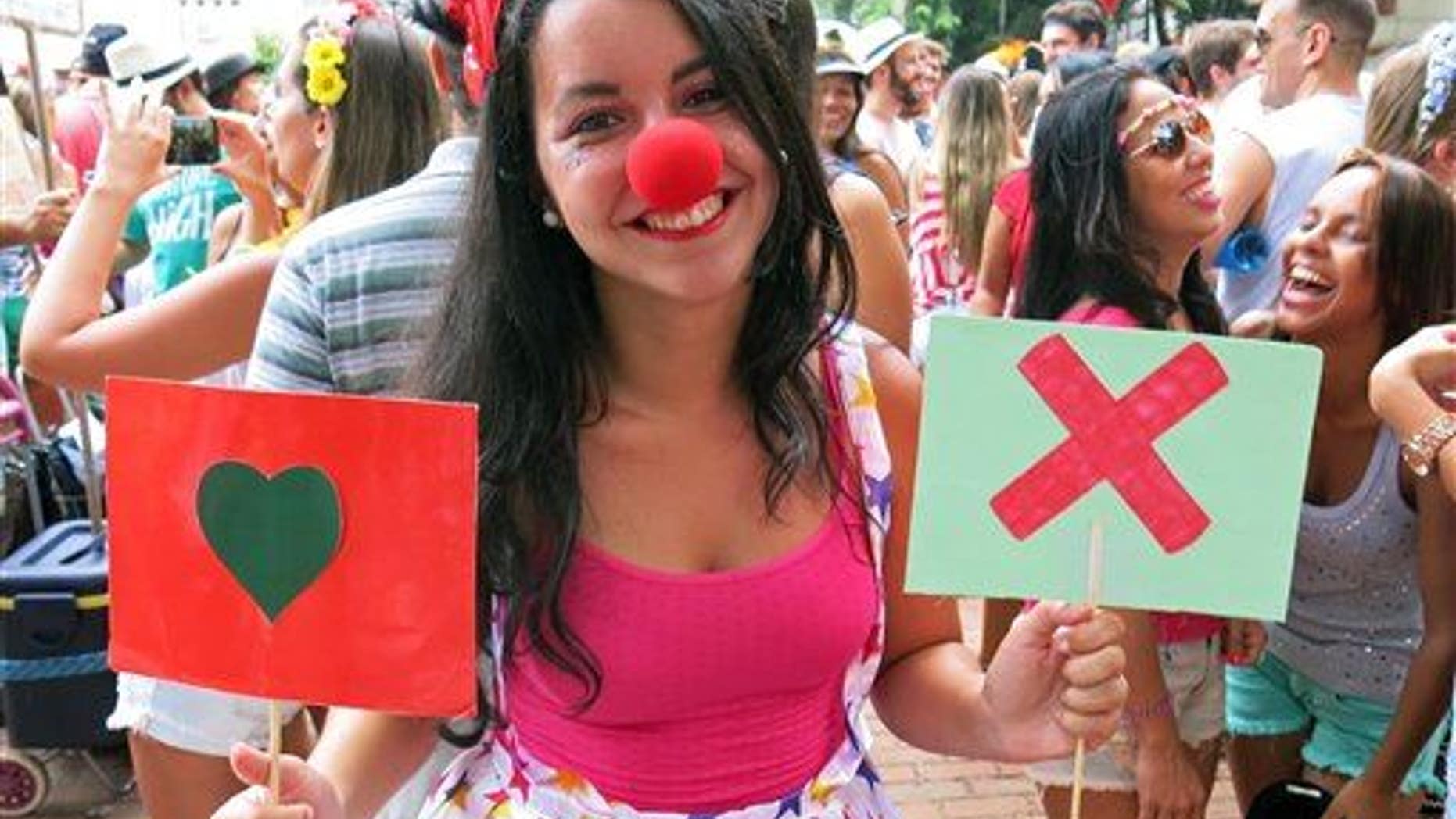 A student holds up placards with symbols used on the hookup app Tinder. Such apps are being blamed on a spike in STDs in Rhode Island.