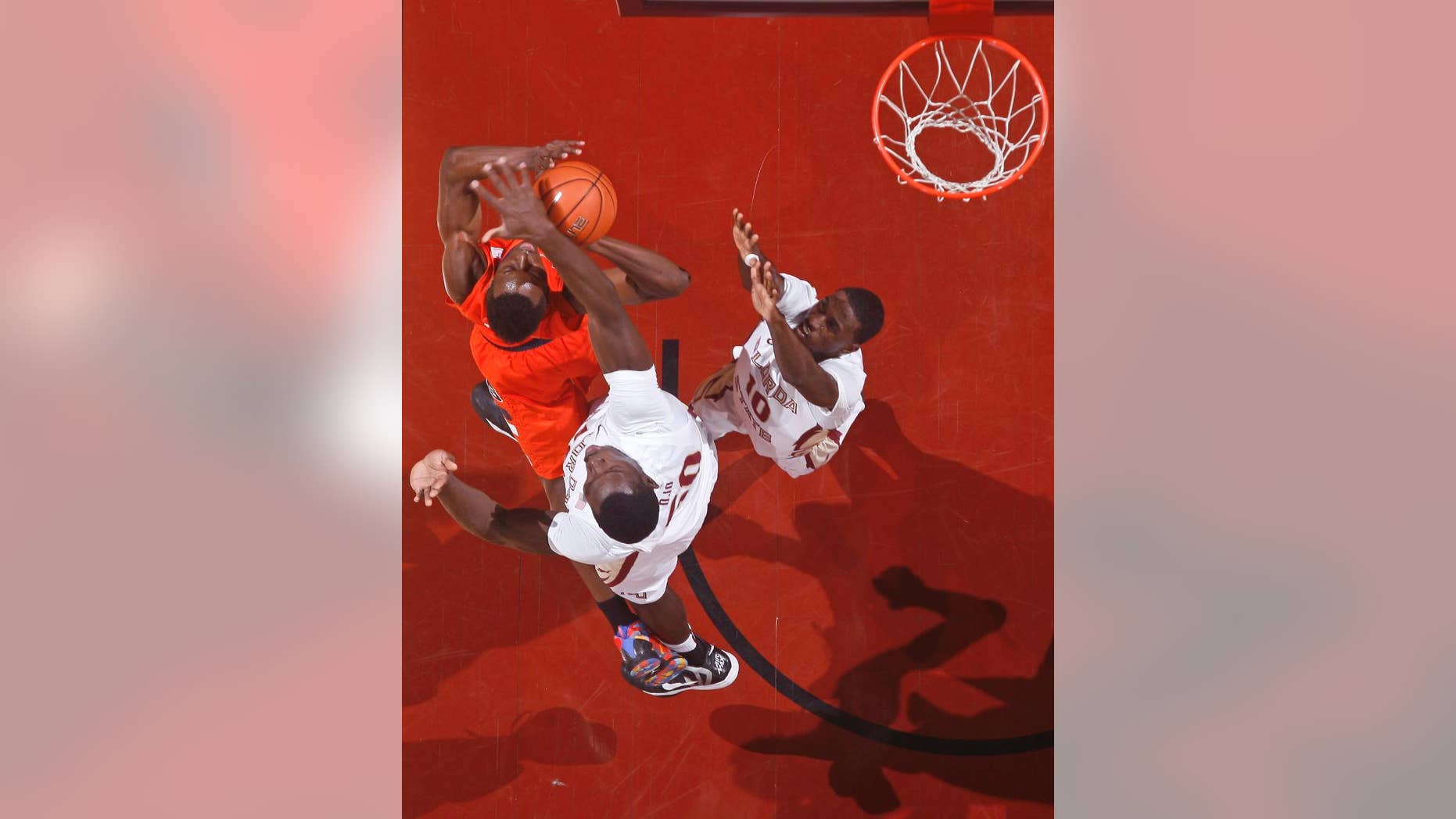 Syracuse forward Jerami Grant, top left, is fouled by Florida State center Michael Ojo (50) as Florida State forward Okaro White (10) defends in the first half of an NCAA college basketball game on Sunday, March 9, 2014, in Tallahassee, Fla. (AP Photo/Phil Sears)