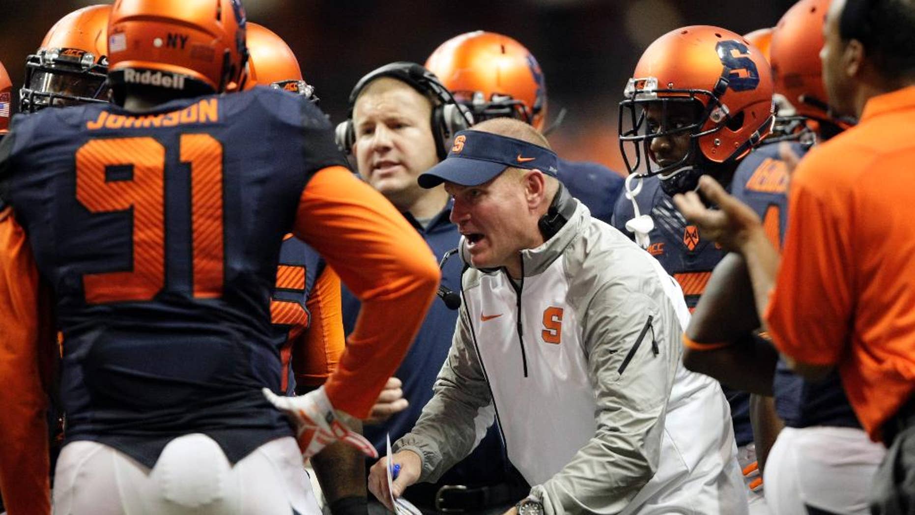 FILE - In this Oct. 3, 2014, file photo, Syracuse’s head coach Scott Shafer talks to his players during a timeout in the third quarter of an NCAA college football game against Louisville in Syracuse, N.Y. Shafer has shuffled his staff as the Orange prepare to host top-ranked Florida State. (AP Photo/Nick Lisi, File)