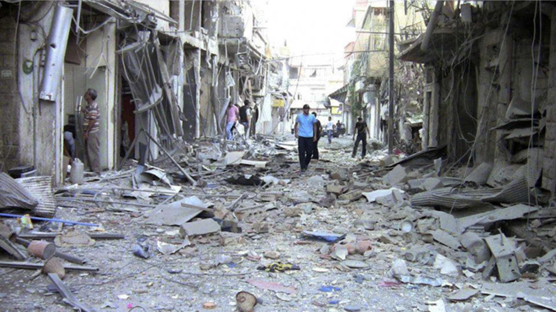 Aug. 8, 2012: This image made from amateur video released by the Shaam News Network purports to show the destruction of houses by shelling from Syrian government forces in Damascus.