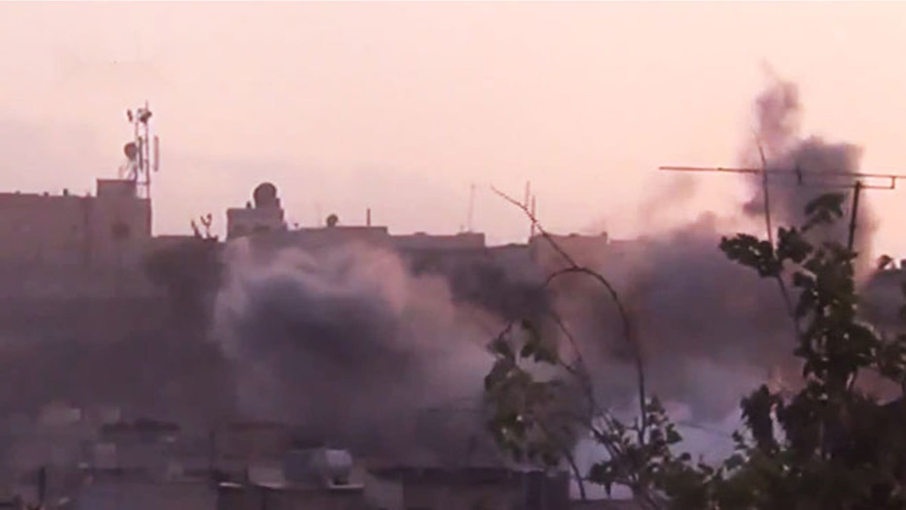 June 26, 2012: In this image made from amateur video released by the Shaam News Network smoke rises from buildings following purported shelling in Homs, Syria.