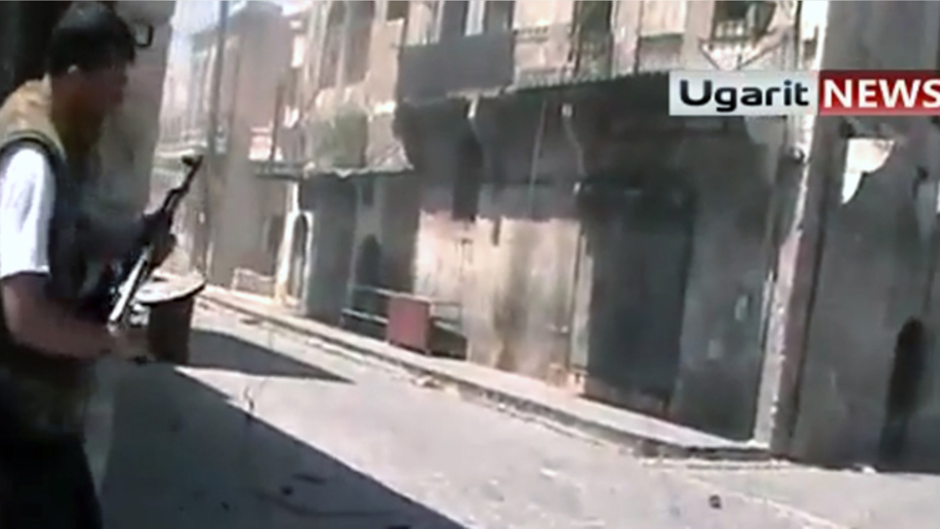 Aug. 26, 2012: A member of a rebel group prepares to fire his weapon at a group of Assad soldiers in street fighting in Aleppo, Syria.