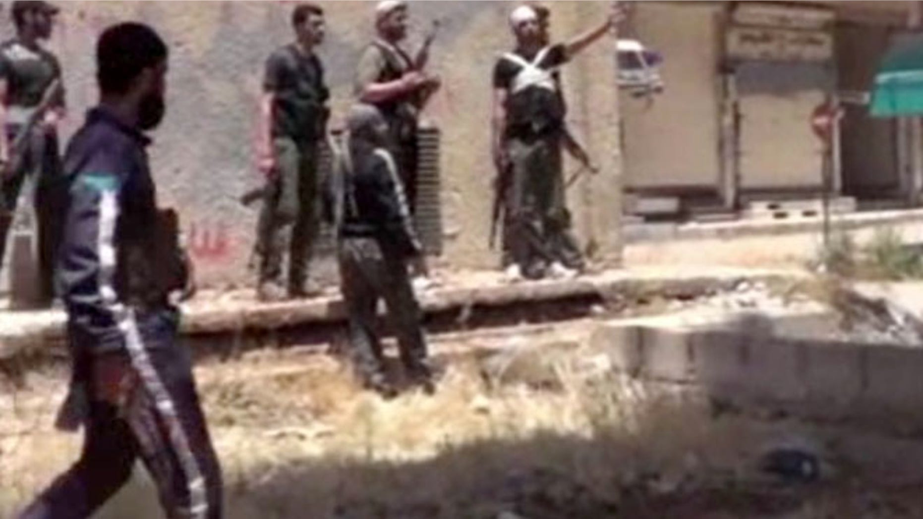May 28, 2013: This image from amateur video obtained by a group which calls itself Ugarit News, which is consistent with AP reporting, shows rebel fighters in Daraa, Syria. Europe's decision to allow member states to arm Syrian rebels and Russia's renewed pledge to send advanced missiles to the Syria regime could spur an arms race in an already brutal civil war and increasingly turn it into a East-West proxy fight.