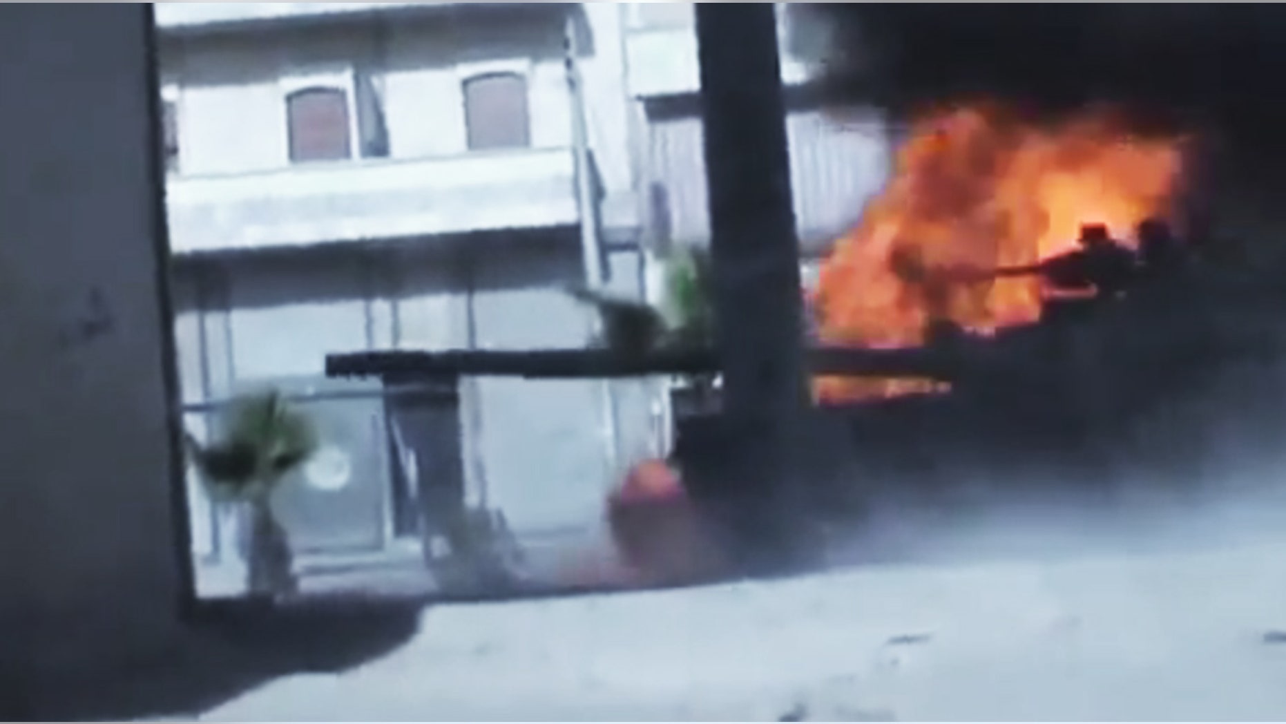 July 23, 2012: In this image made from amateur video released by the Ugarit News, Syrian government troops are seen on a military tank as it catches on fire during clashes with Free Syrian Army soldiers in Aleppo, Syria.