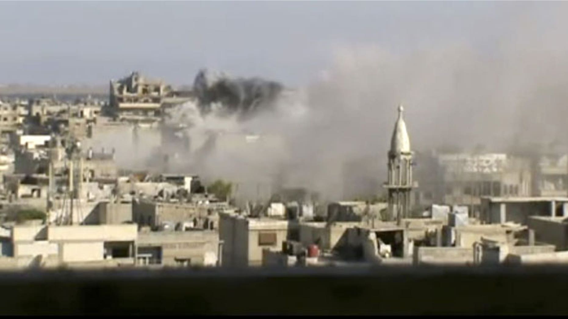 June 8, 2012: This image made from amateur video released by Shaam News Network purports to show explosions in the Khaldiyeh area of Homs, Syria.