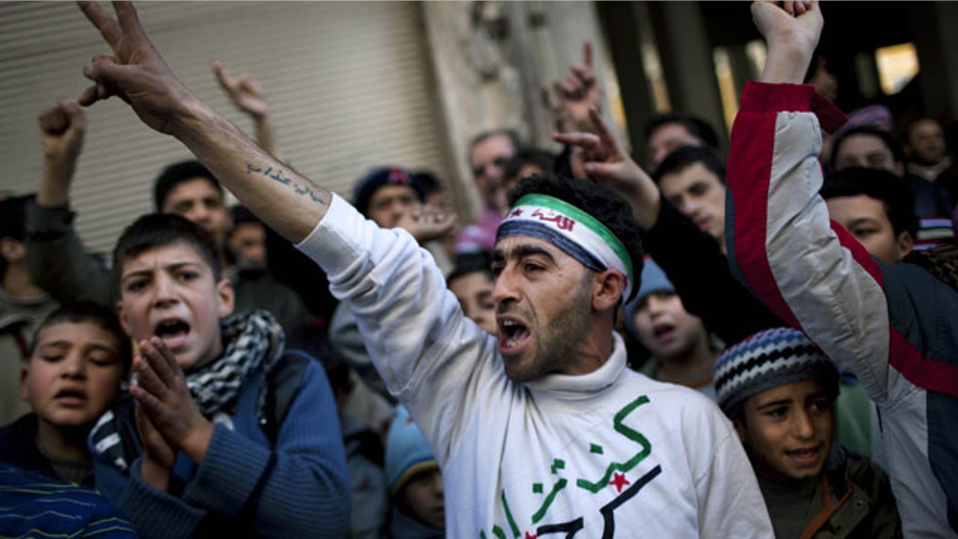 Feb. 24, 2012: People chant slogans against Syrian President Bashar Al-Assad's regime during a demonstration in Kafar Taharim, northern Syria.
