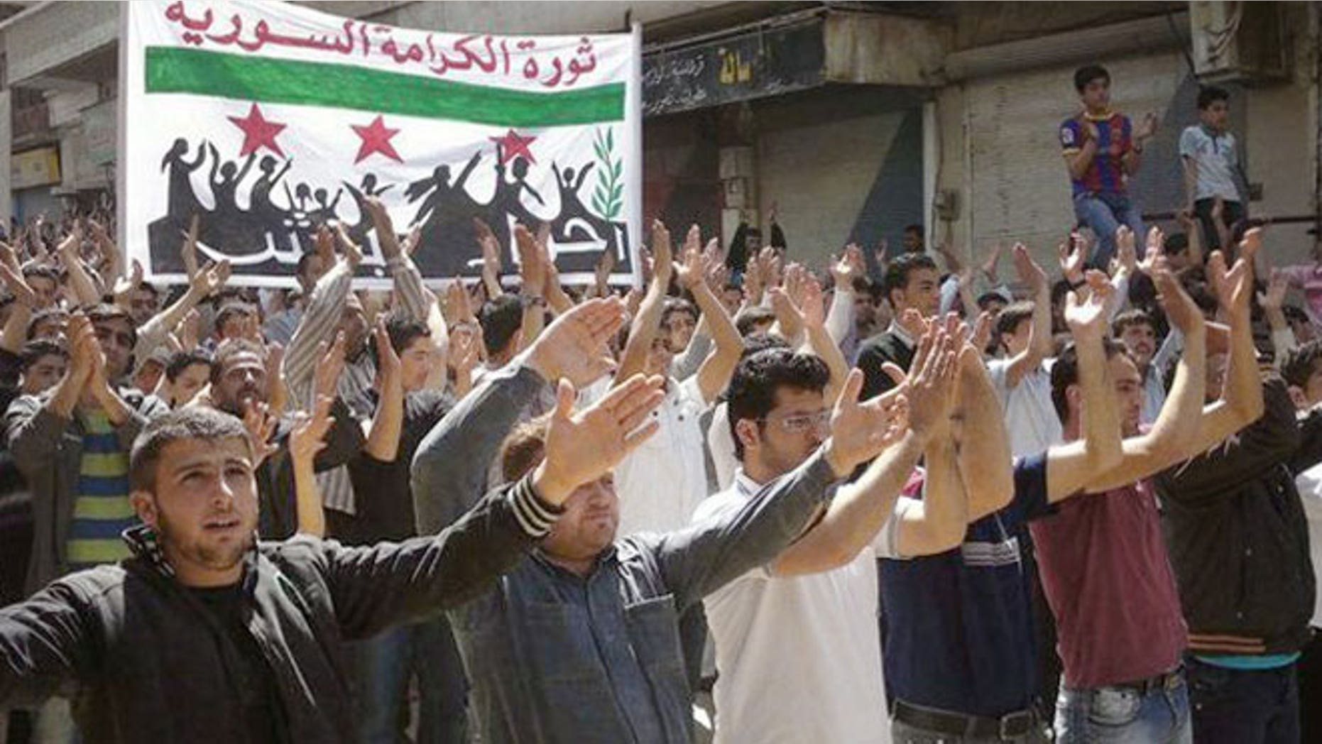 April 6, 2012: In this citizen journalism image provided by the Local Coordination Committees in Syria, Syrians chant slogans during a demonstration in Idlib, north Syria.