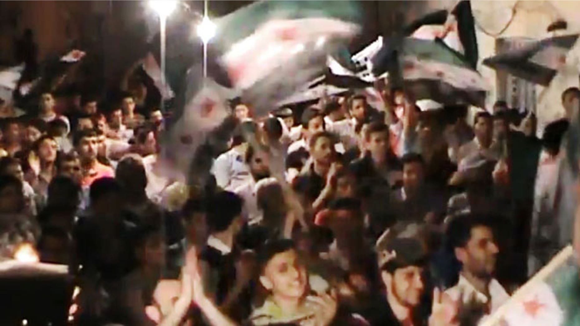 This image made from amateur video and released by the Syria media center Tuesday, May 1, 2012, purports to show Syrians chanting slogans during a demonstration in Aleppo, Syria.
